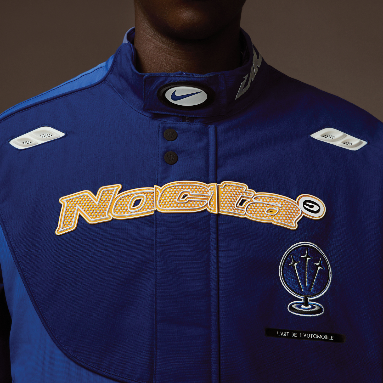 Nocta Nike & L'art de l'automobile's blue racing jacket collab