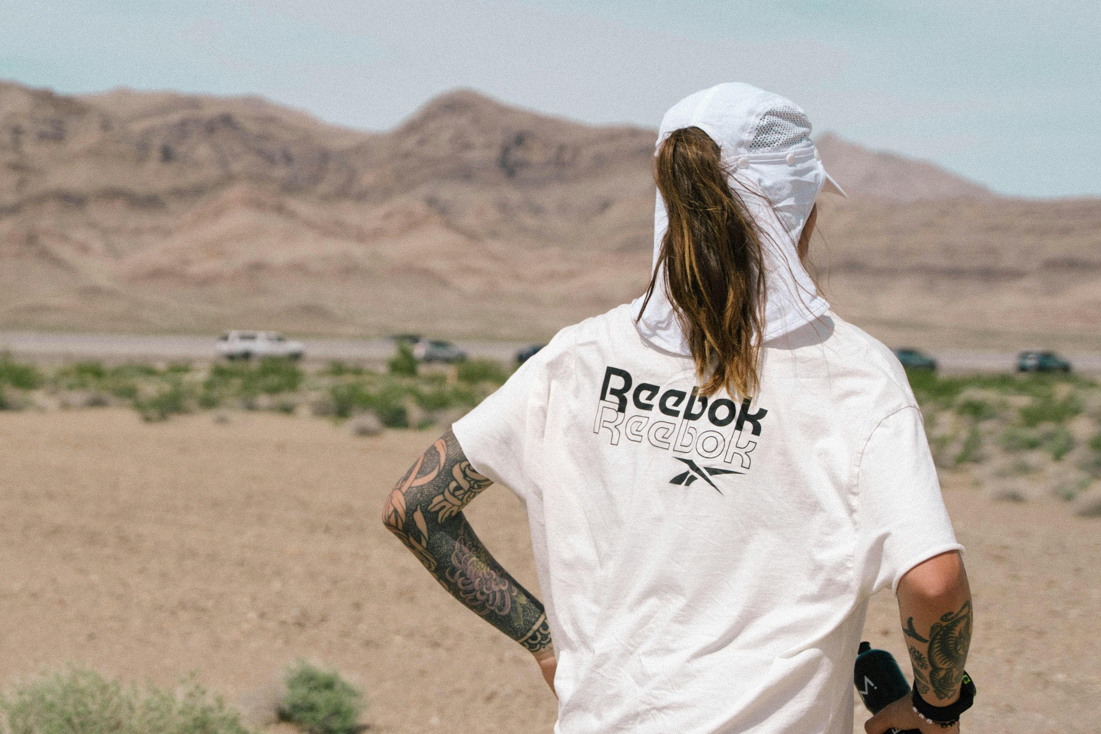 Woman running against dry landscape background