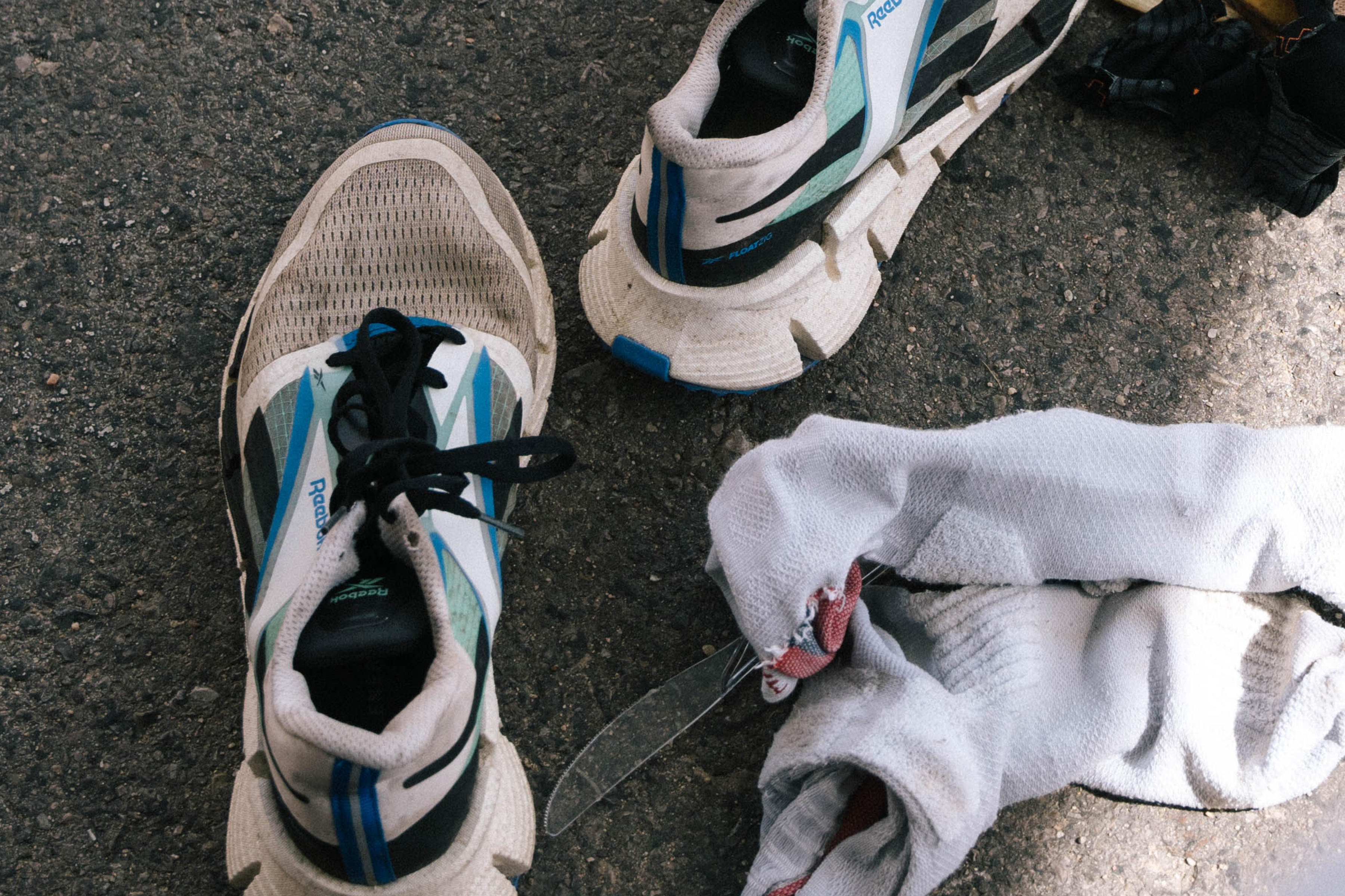 Close-up of used, dirty running shoes and tools