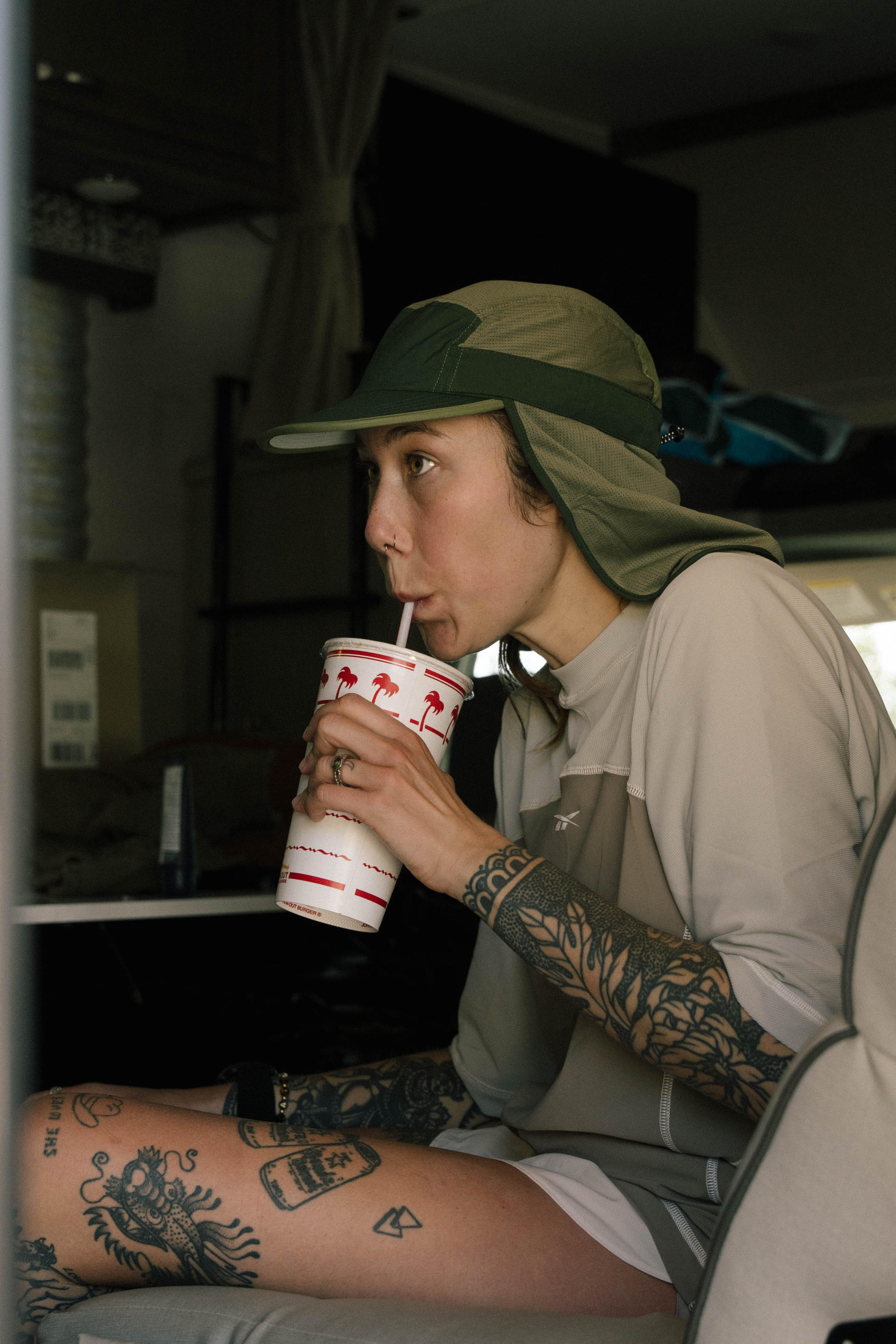 Close-up of athlete drinking from a straw in a van