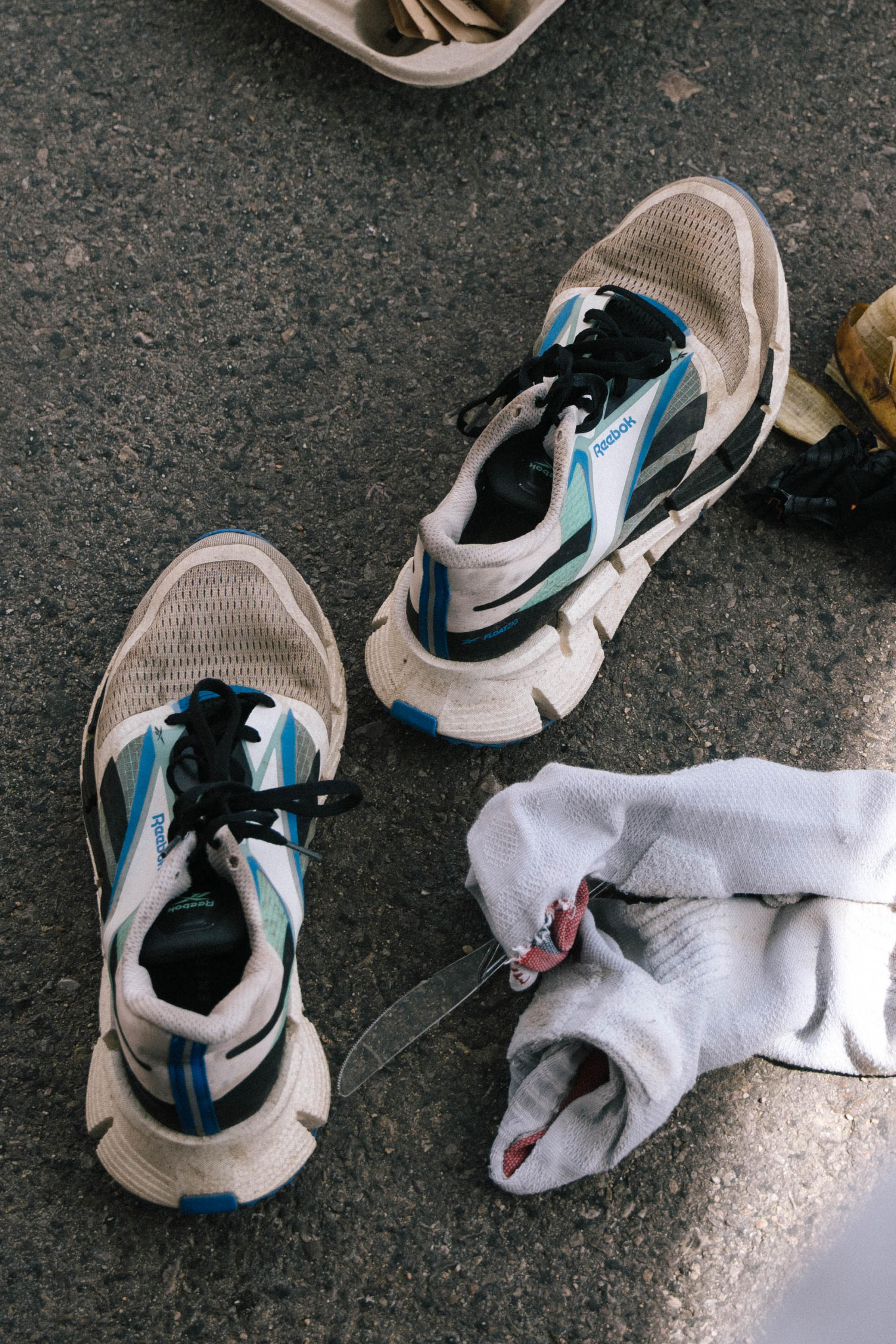 Close-up of dirty, well used running shoes and tools