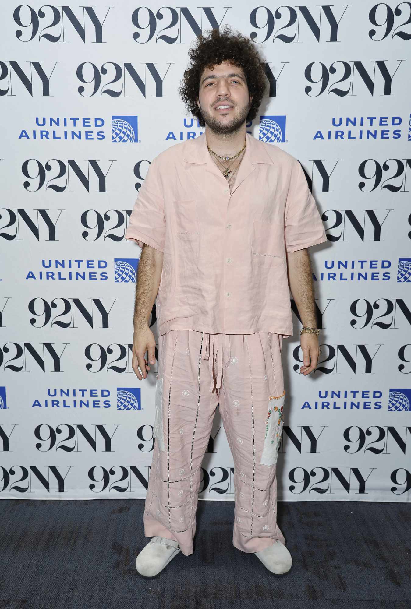 Benny Blanco wearing a beige short-sleeved shirt on the red carpet