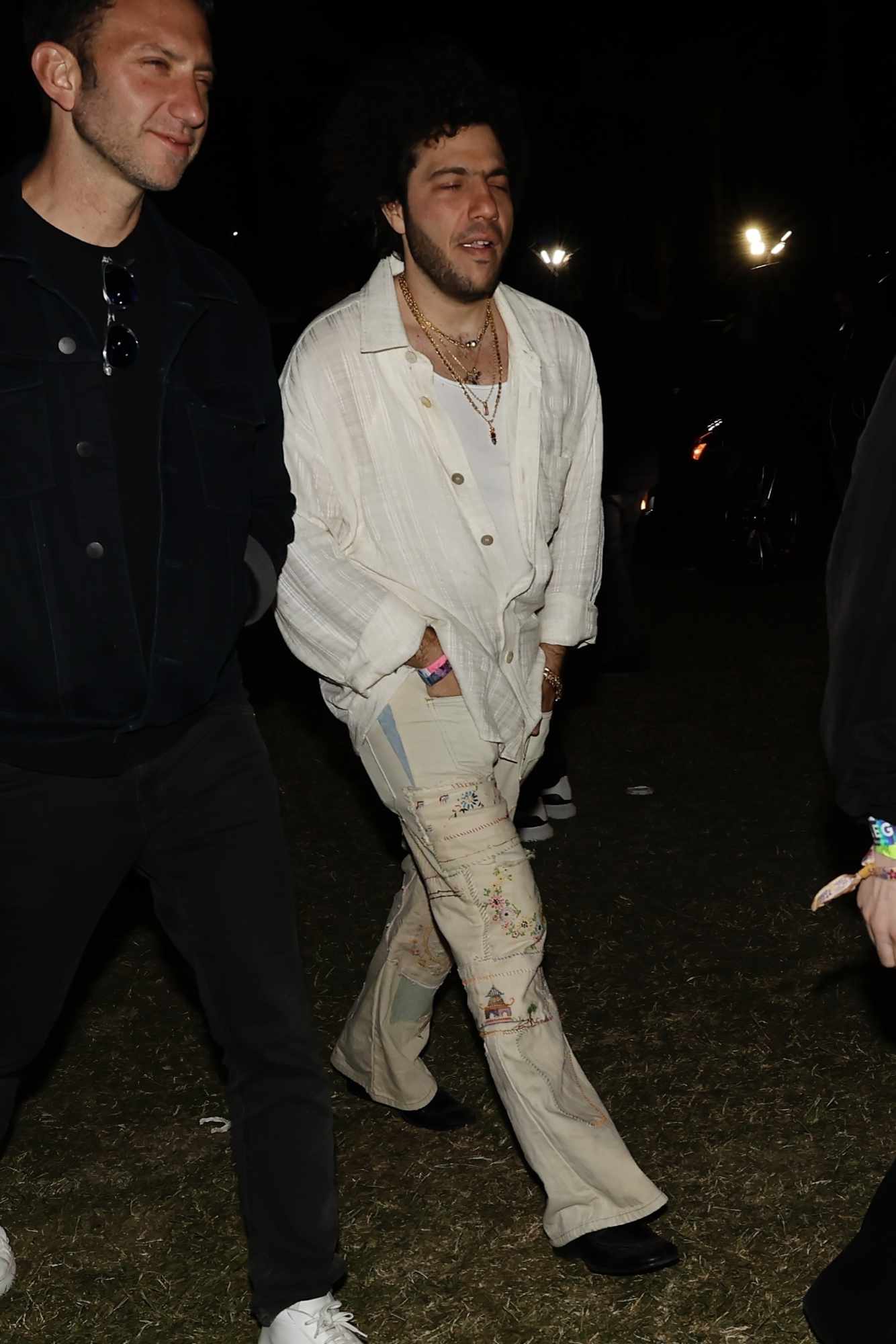 Benny Blanco wearing a white shirt and beige pants at Coachella 2024