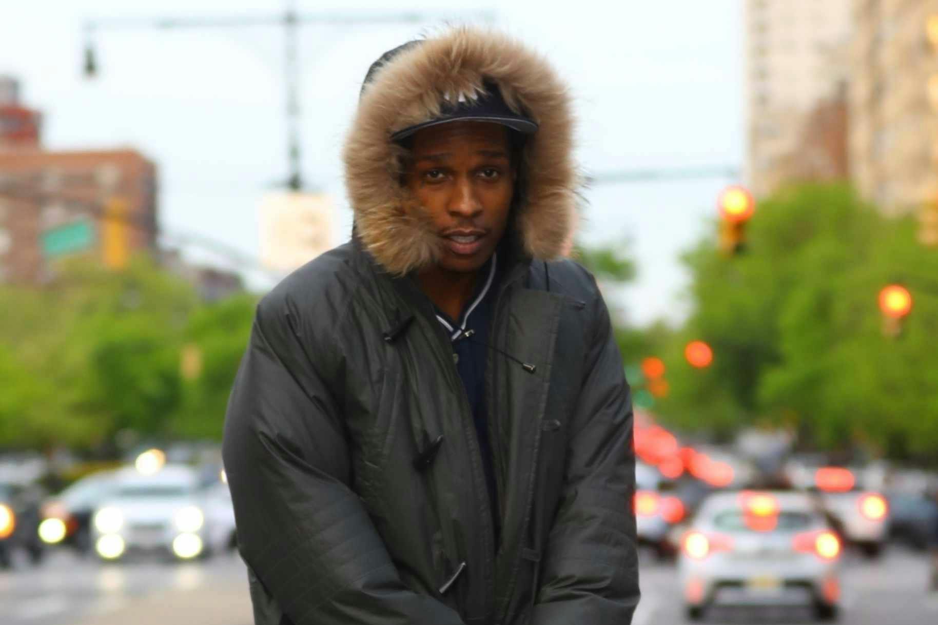 A$AP Rocky wears a fur-hooded coat, baggy jeans, and timberland boots on the set of Spike Lee's new movie