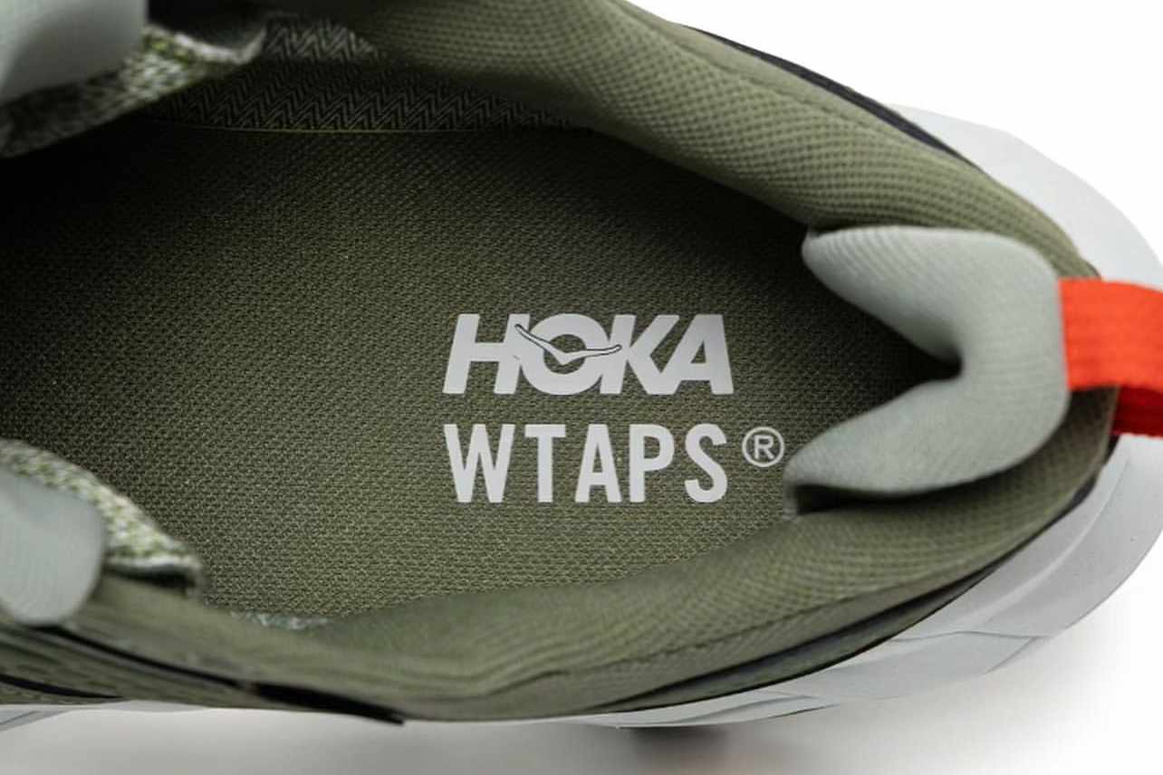 HOKA & WTAPS' green Anacapa 2 Low GTX sneaker collaboration seen from the logos on the insole