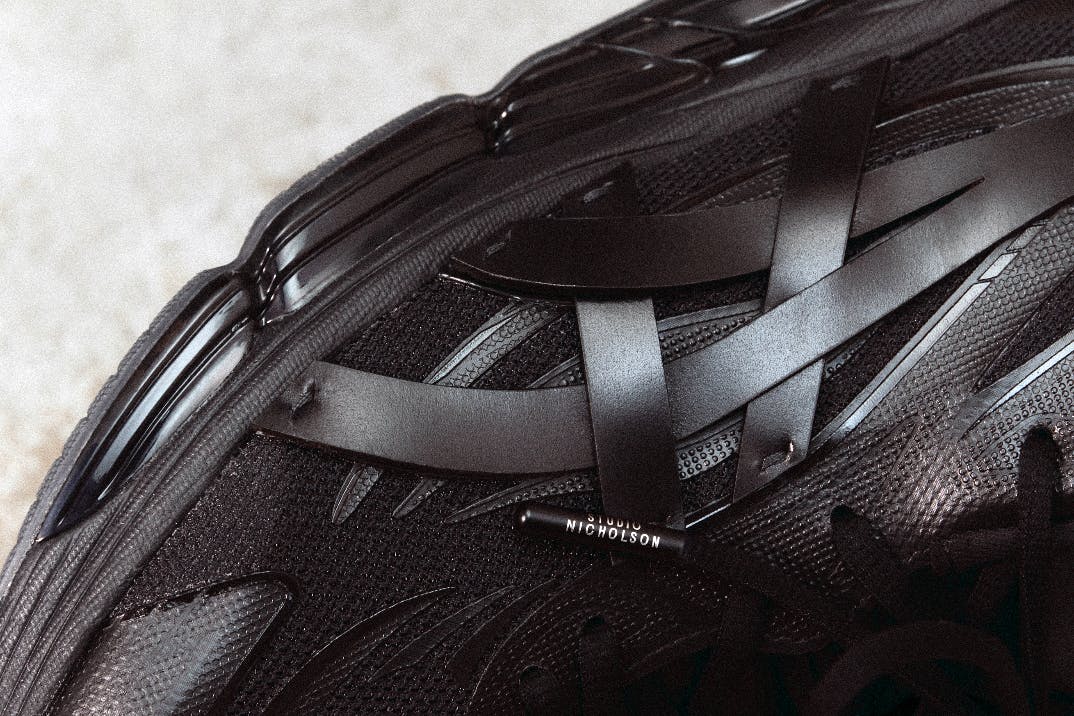 Studio Nicholson's ASICS sneaker in black mesh and leather with branded shoelaces