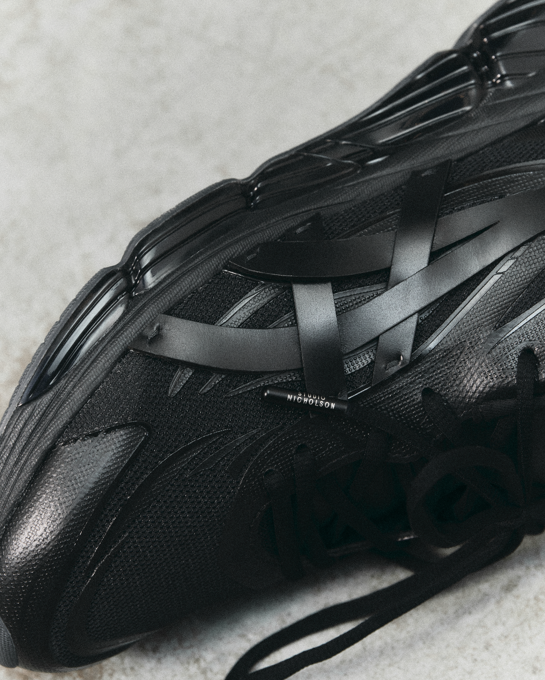 Studio Nicholson's ASICS sneaker in black mesh and leather with branded shoelaces