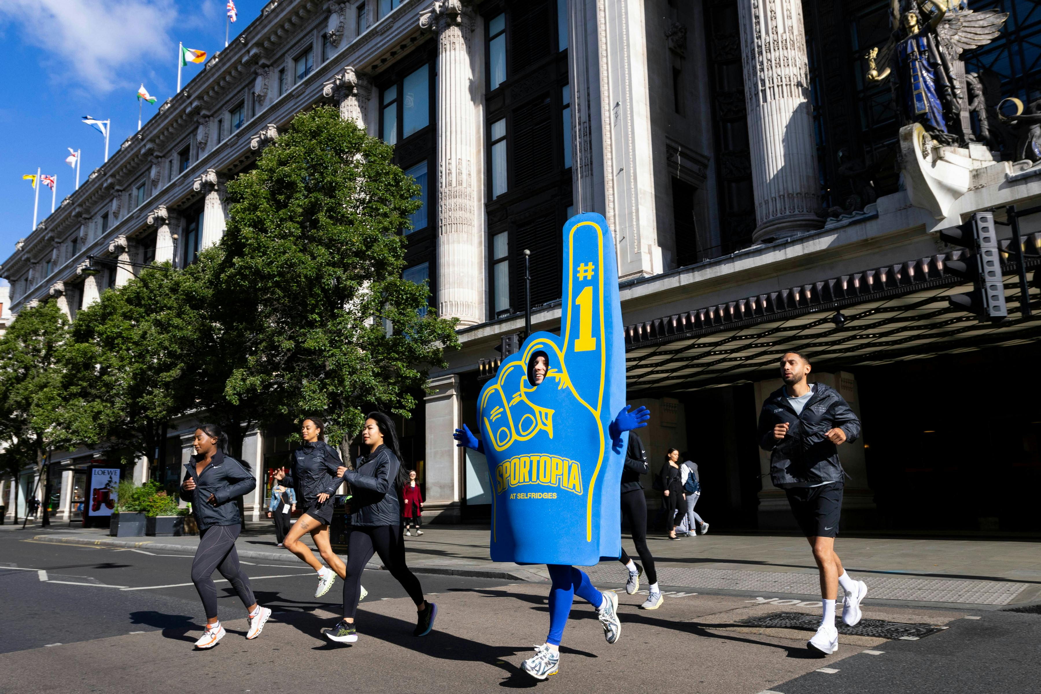 Man running in Foam Finger costume