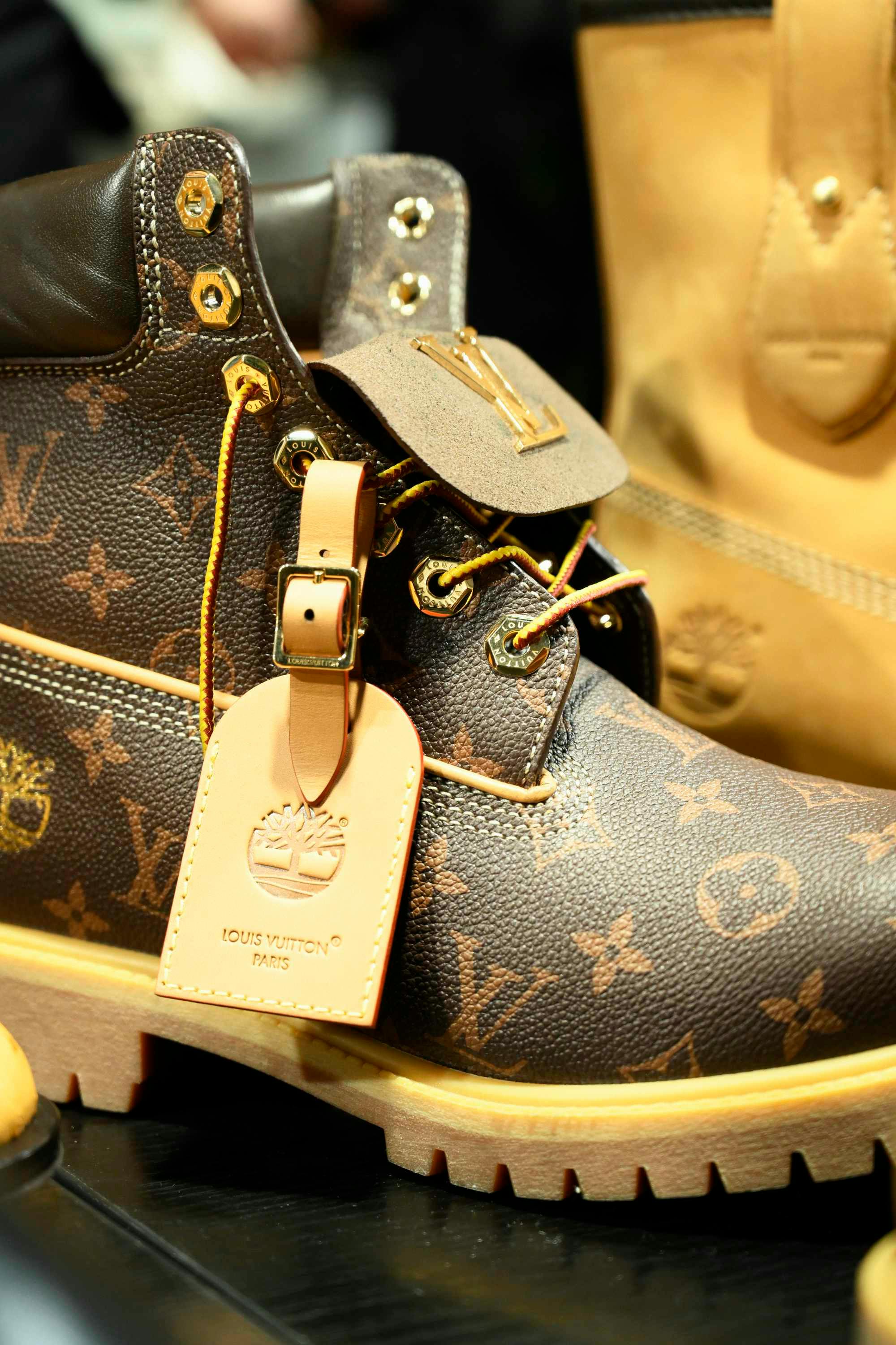 Louis Vuitton's Timberland boot collab revealed by Pharrell Williams, including beige and black 6" leather boots and ranger-style pull ons in Louis Vuitton-monogrammed boxes