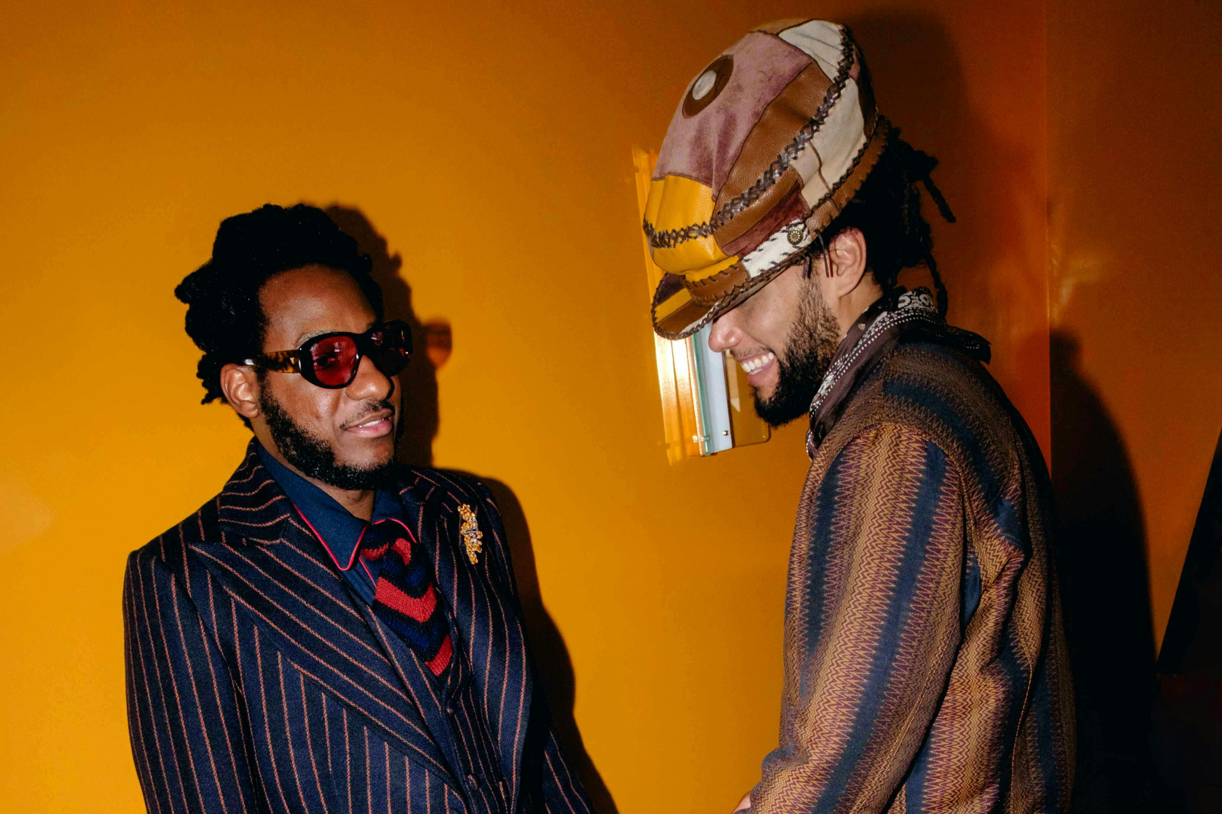 Nicholas Daley adjusts Leon Bridges' suit.