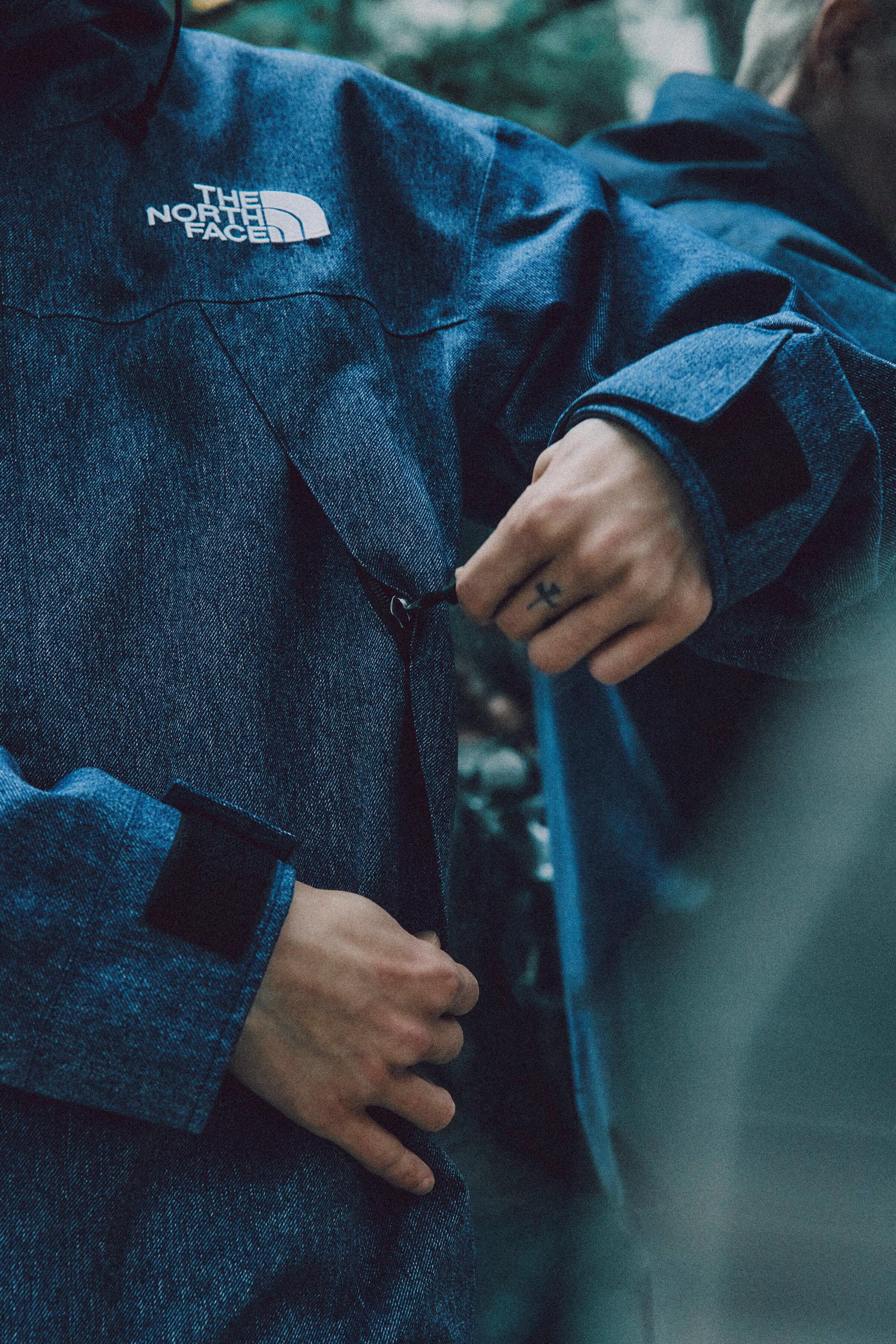 Models wear The North Face's denim GORE-TEX clothing capsule, comprising indigo-dyed jackets, pants, and accessories.