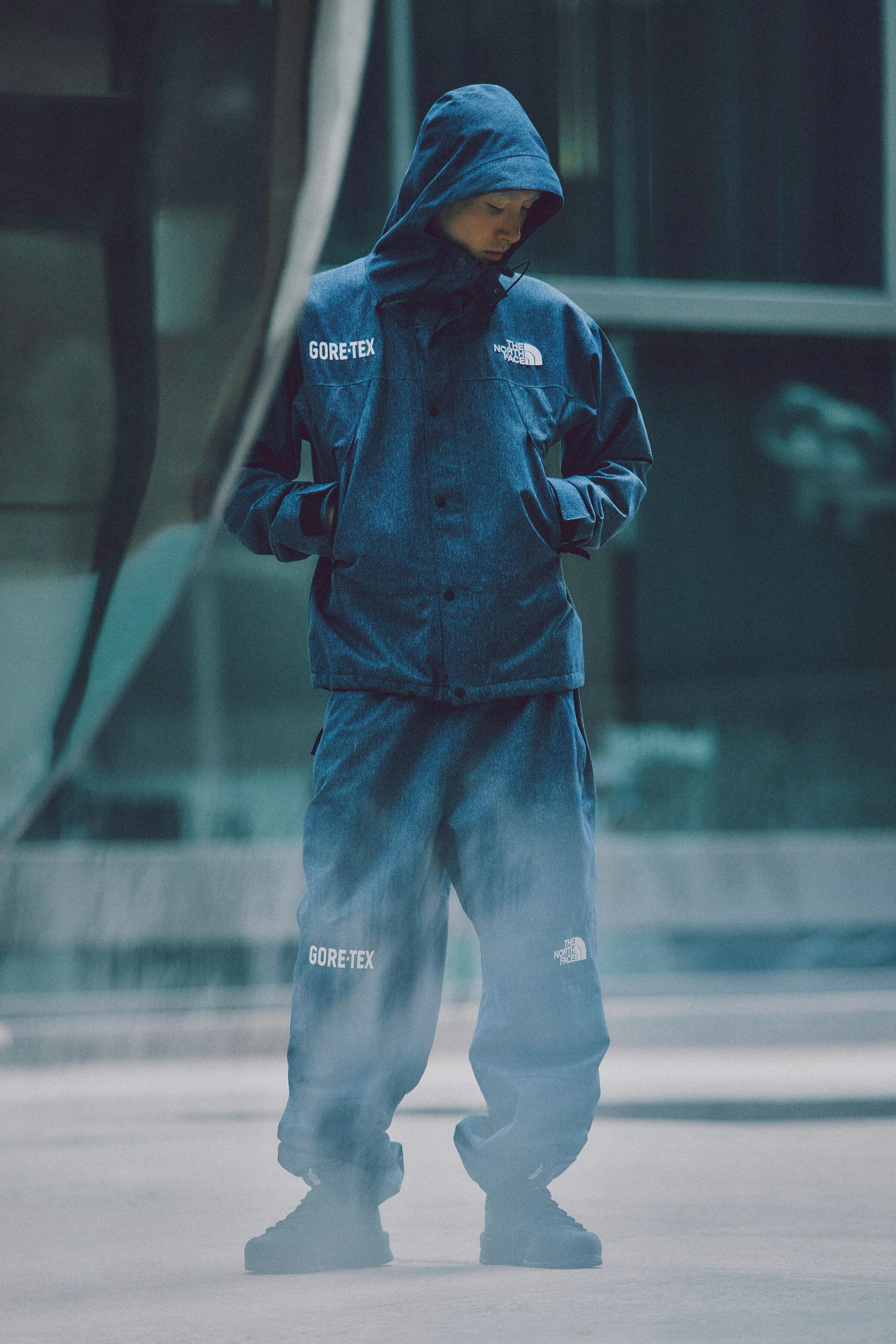 Models wear The North Face's denim GORE-TEX clothing capsule, comprising indigo-dyed jackets, pants, and accessories.