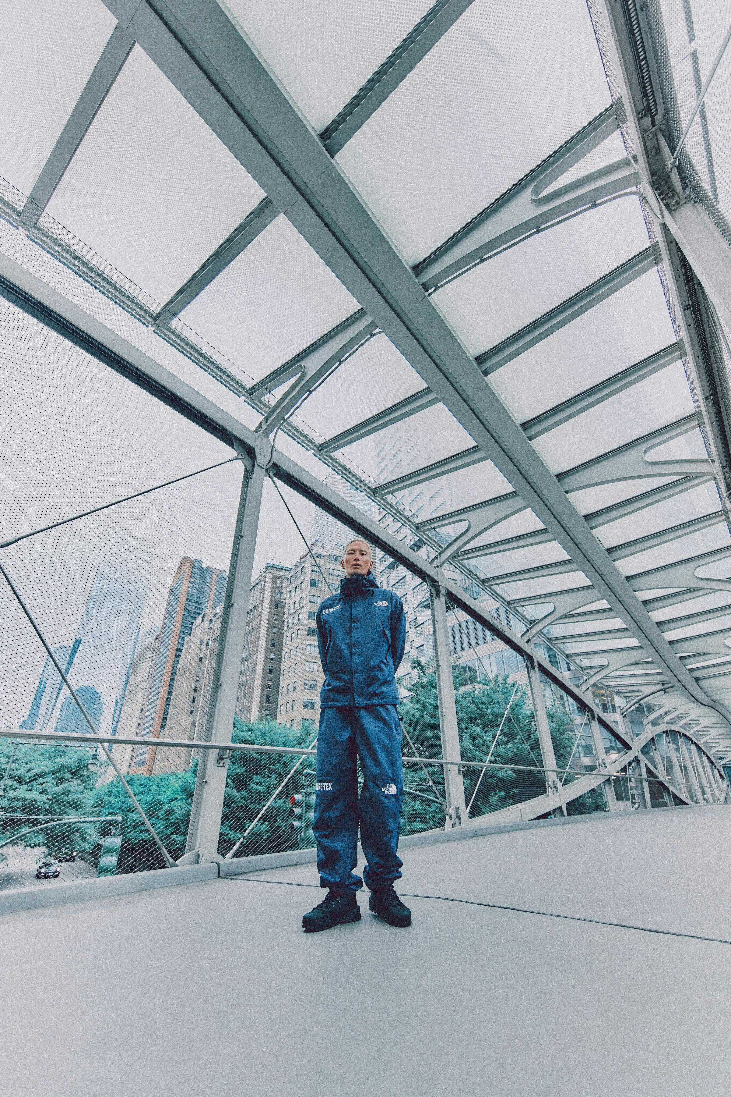 Models wear The North Face's denim GORE-TEX clothing capsule, comprising indigo-dyed jackets, pants, and accessories.