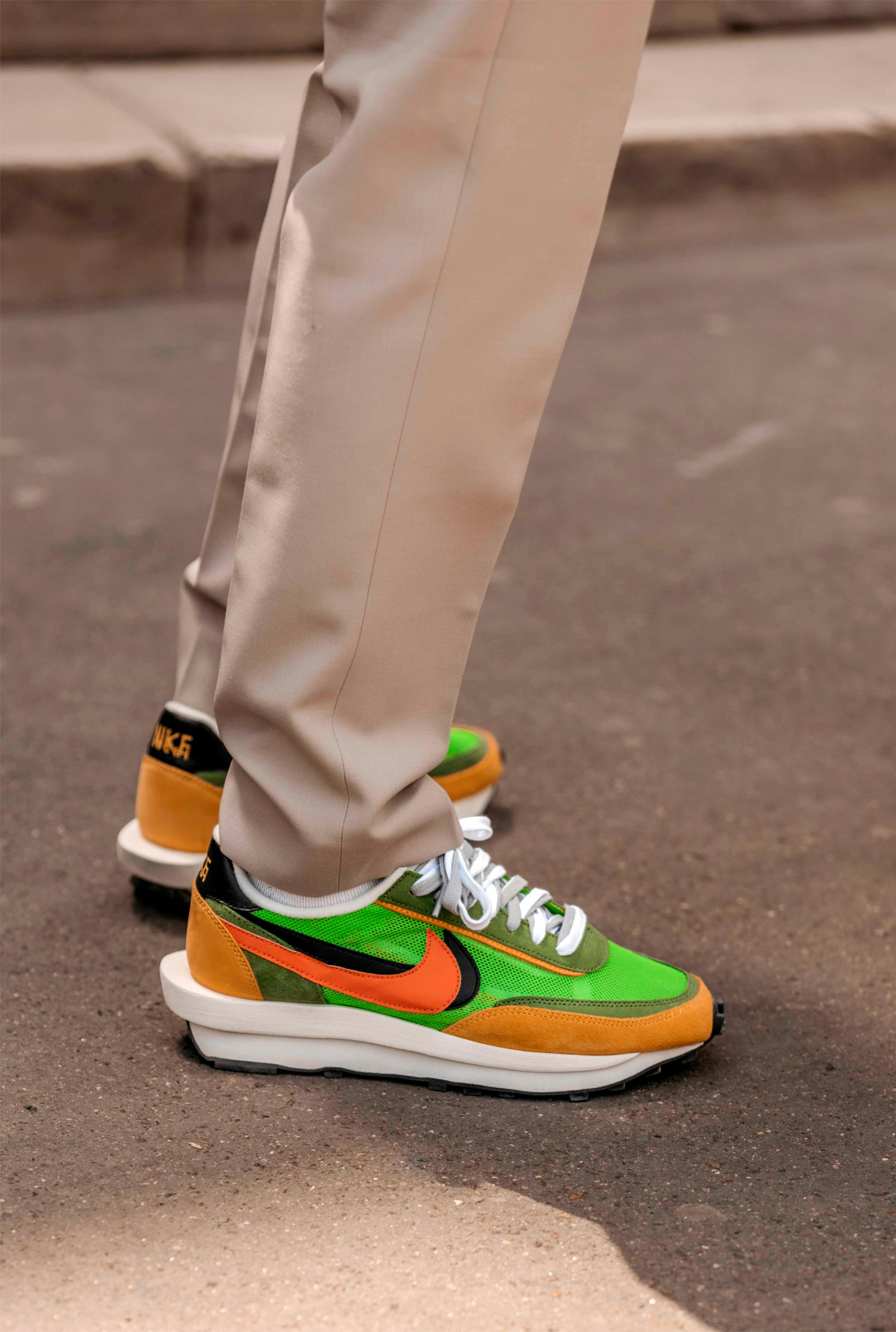 nike sacai ldwaffle sneaker collaboration in green white and yellow colorway worn with beige pants