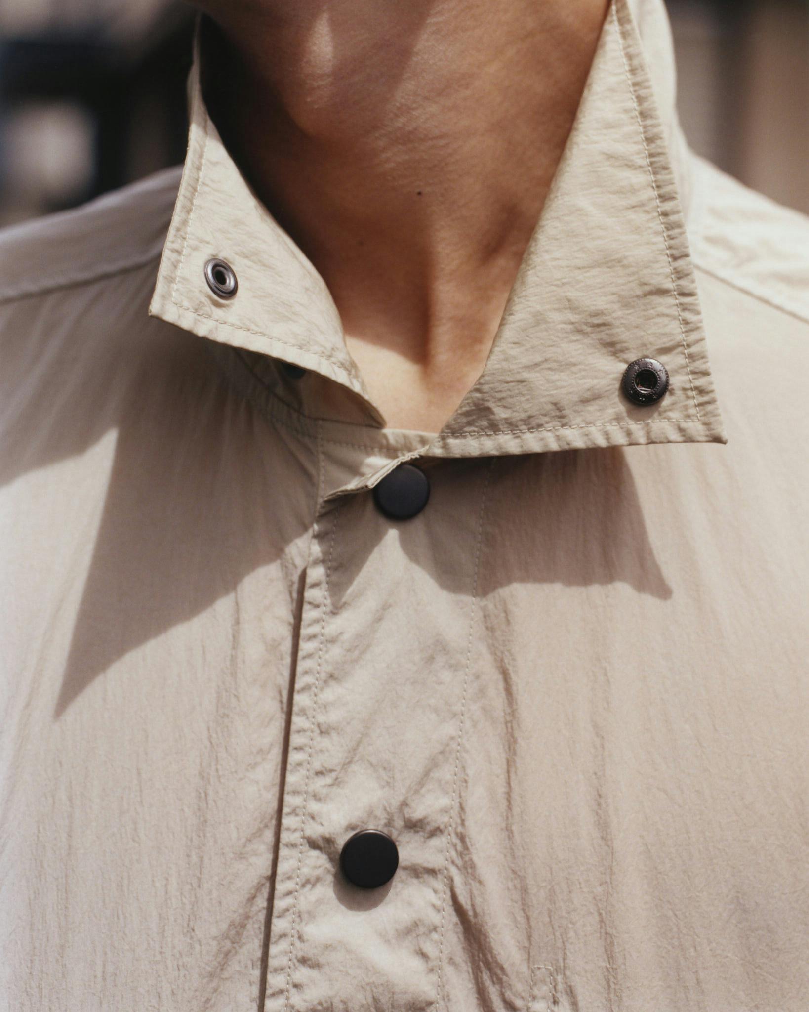 Close detail of the collar and hardware on a pale Morrow jacket
