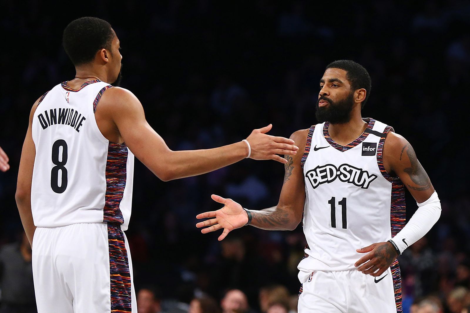 Kyrie Irving #11 of the Brooklyn Nets celebrates with Spencer Dinwiddie #8