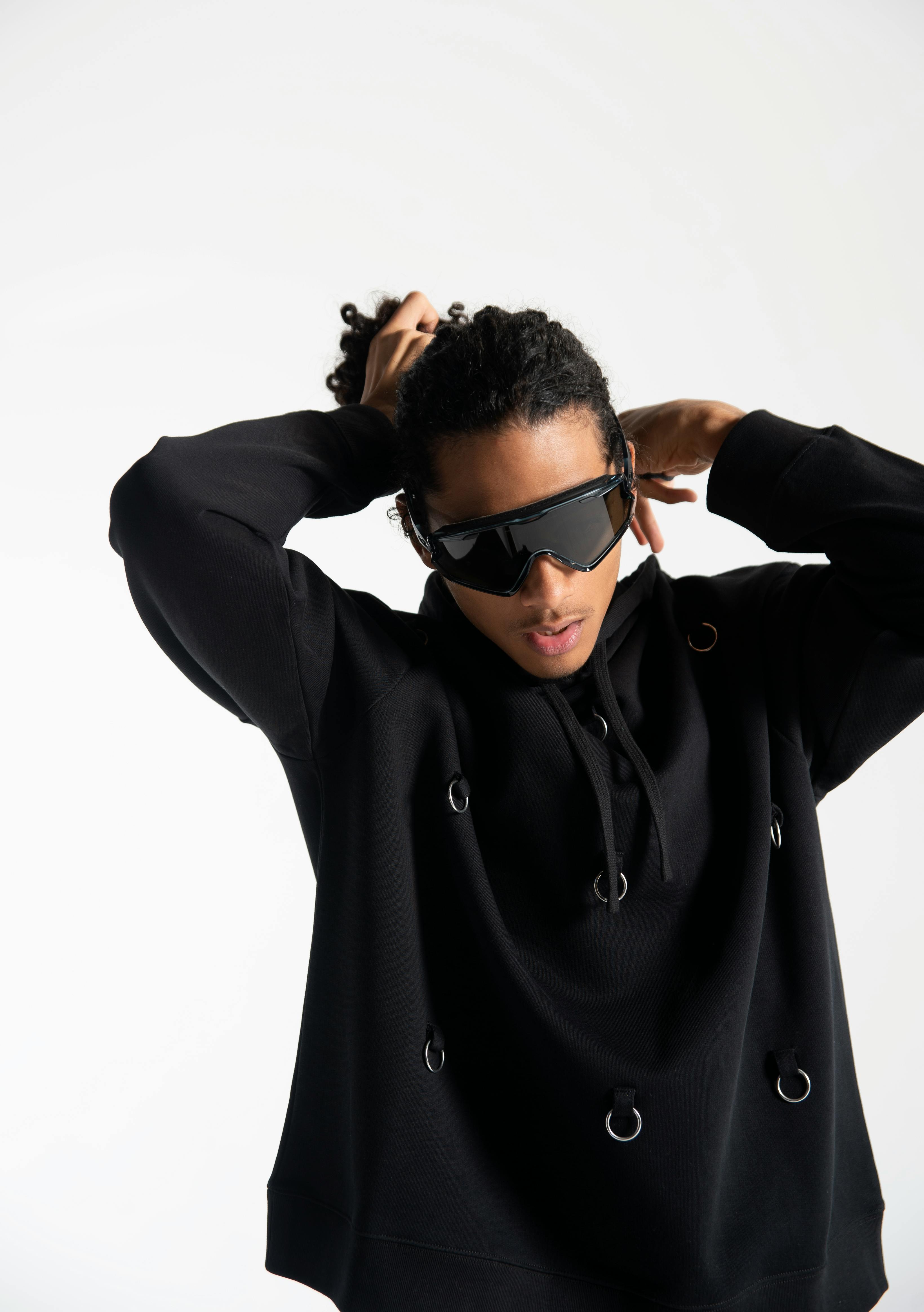 Sweater by Raf Simons. Sunglasses by Oakley. Pants by Billy.