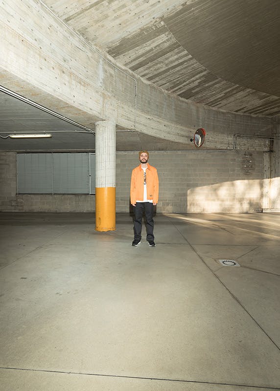 Gregorio Perrucci wears a Dickies jacket, Bape long sleeve t-shirt, Dickies pants and a Patta x Carhartt beanie.