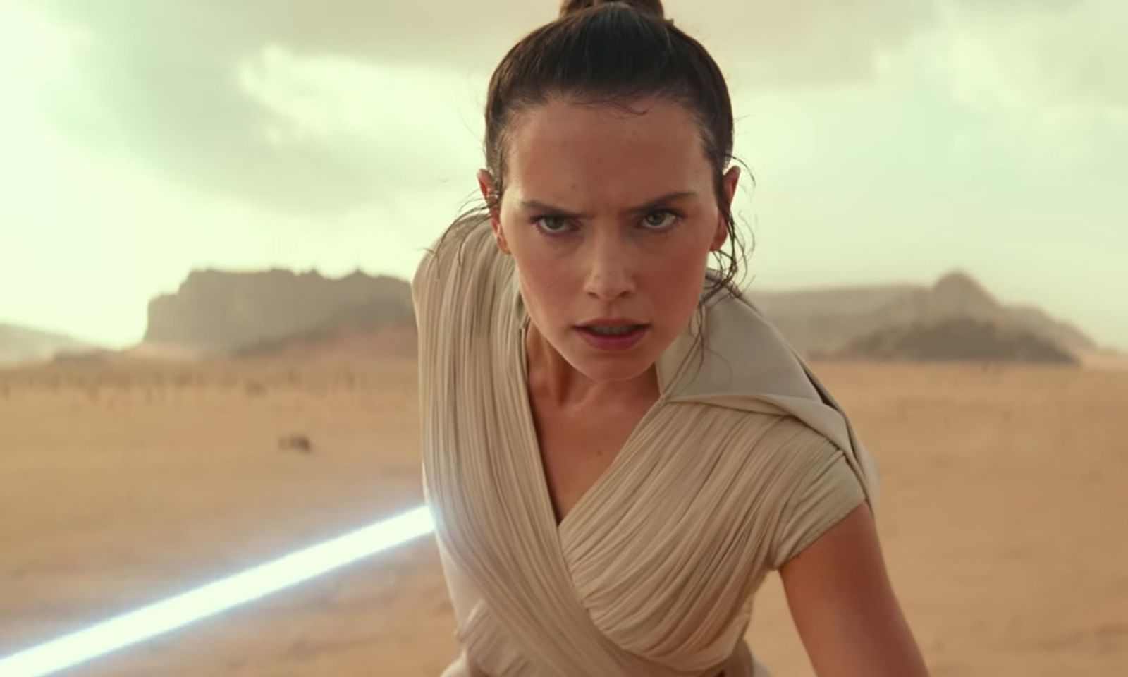 Star Wars: The Rise of Skywalker closeup in desert with lightsaber
