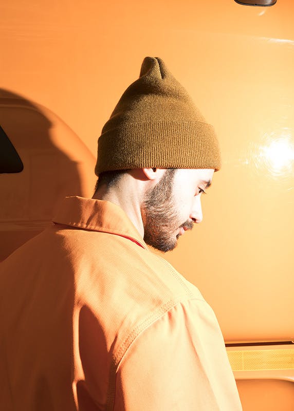 Gregorio Perrucci wears a Dickies jacket, Bape long sleeve t-shirt, Dickies pants and a Patta x Carhartt beanie.