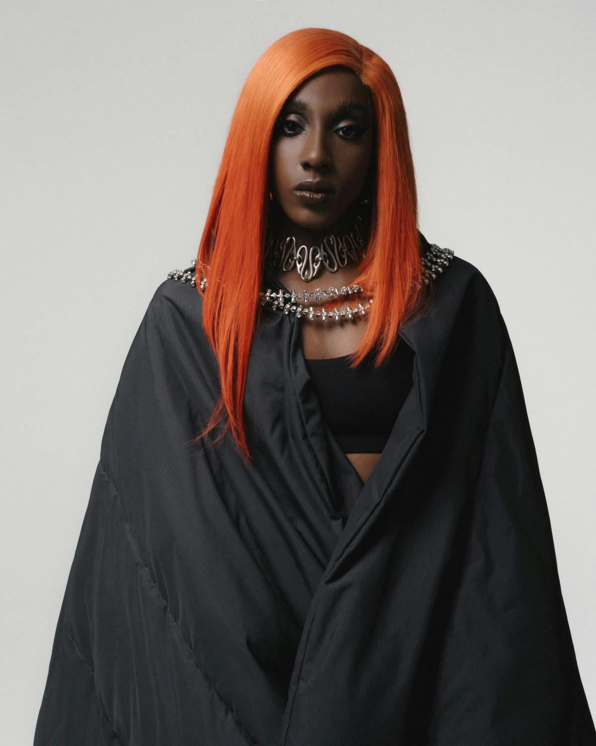 Bra PUMA Skirt, blanket, and shoes BALENCIAGA Sunglasses and top necklace CHRISHABANA Earrings and rings PANCONESI Hairpiece worn as necklace GIVENCHY