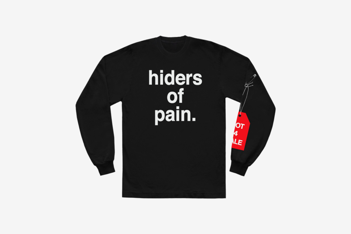 image of Andre' 3000's new sweater with slogan from tour jumpsuits