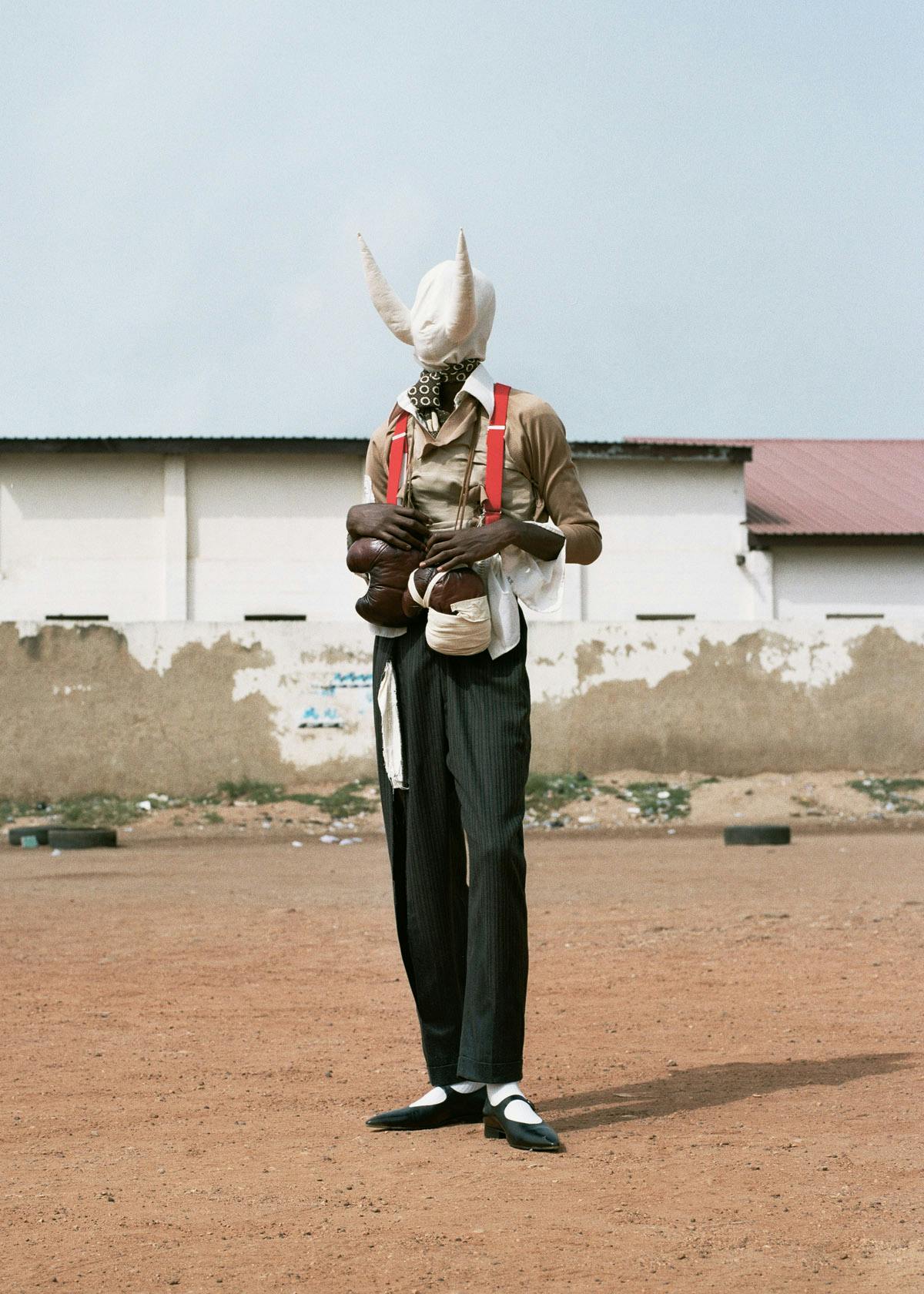 top, pants, suspenders, scarf & shoes MAISON MARGIELA headpiece NATHAN MARE boxing gloves GIOVANNI LEONARDO BASSAN