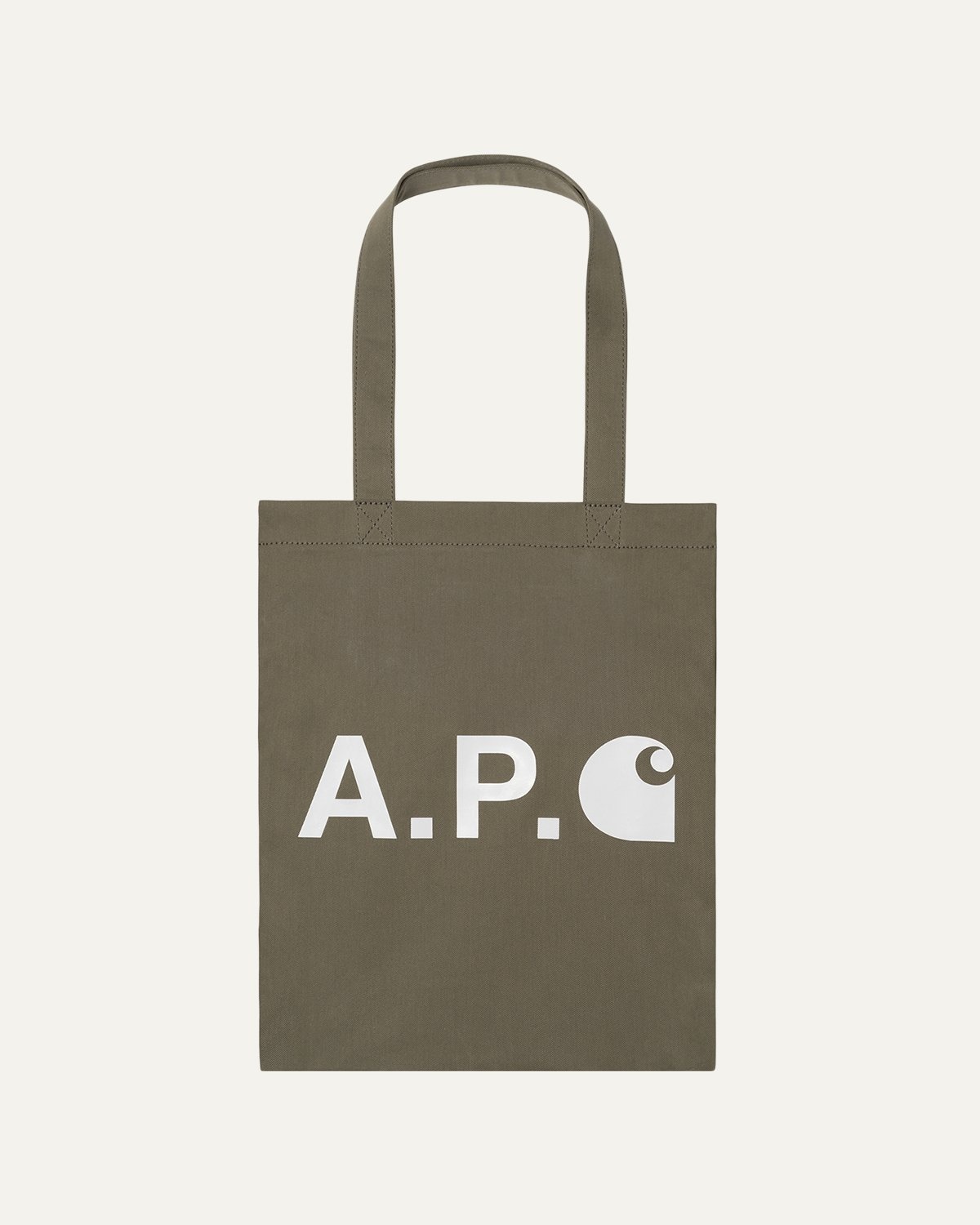 Commonwealth PH - The Alan Tote Bag in Khaki by Carhartt WIP x A.P.C.  features a large contrasting Carhartt x A.P.C. logo on cotton twill, and is  meant to be carried on