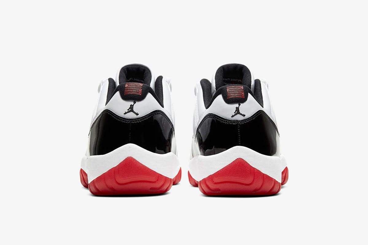 Product image of Nike Air Jordan 11 low in a black, white, and red colorway