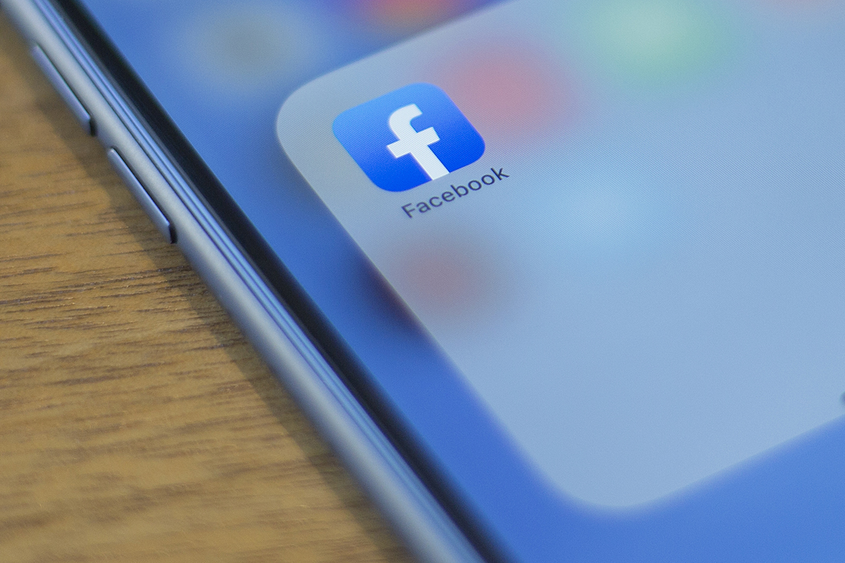 The Facebook logo is seen on a phone