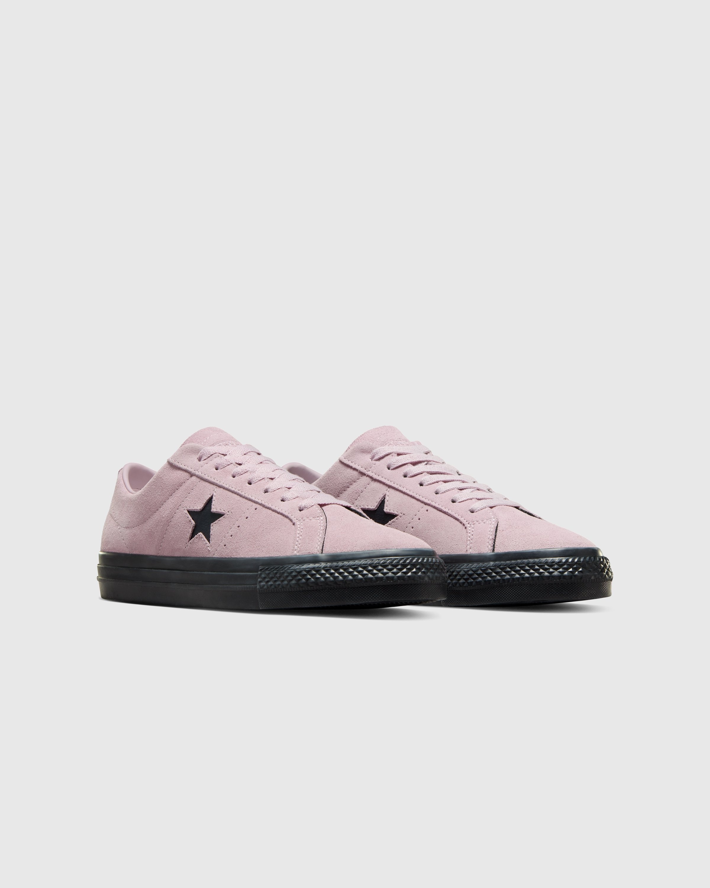 Pink suede converse top one star