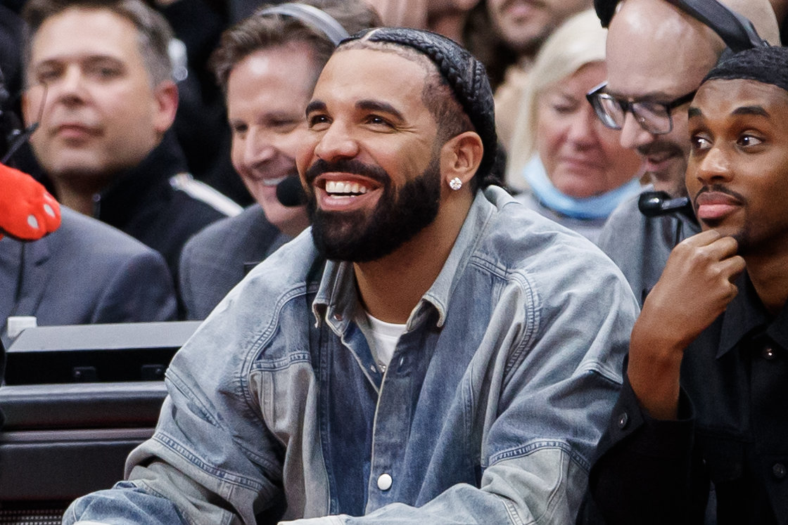 TORONTO, ON - NOVEMBER 23: Rapper Drake smiles as he sits courtside with Future The Prince during the second half of the NBA game between the Toronto Raptors and the Brooklyn Nets at Scotiabank Arena on November 23, 2022 in Toronto, Canada. NOTE TO USER: User expressly acknowledges and agrees that, by downloading and or using this photograph, User is consenting to the terms and conditions of the Getty Images License Agreement. (Photo by Cole Burston/Getty Images)