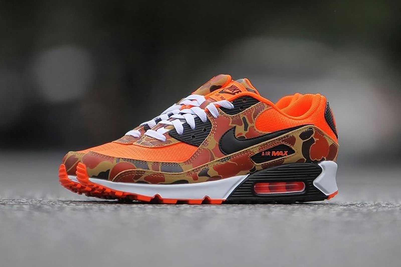 Side view of orange duck camo Nike Air Max 90