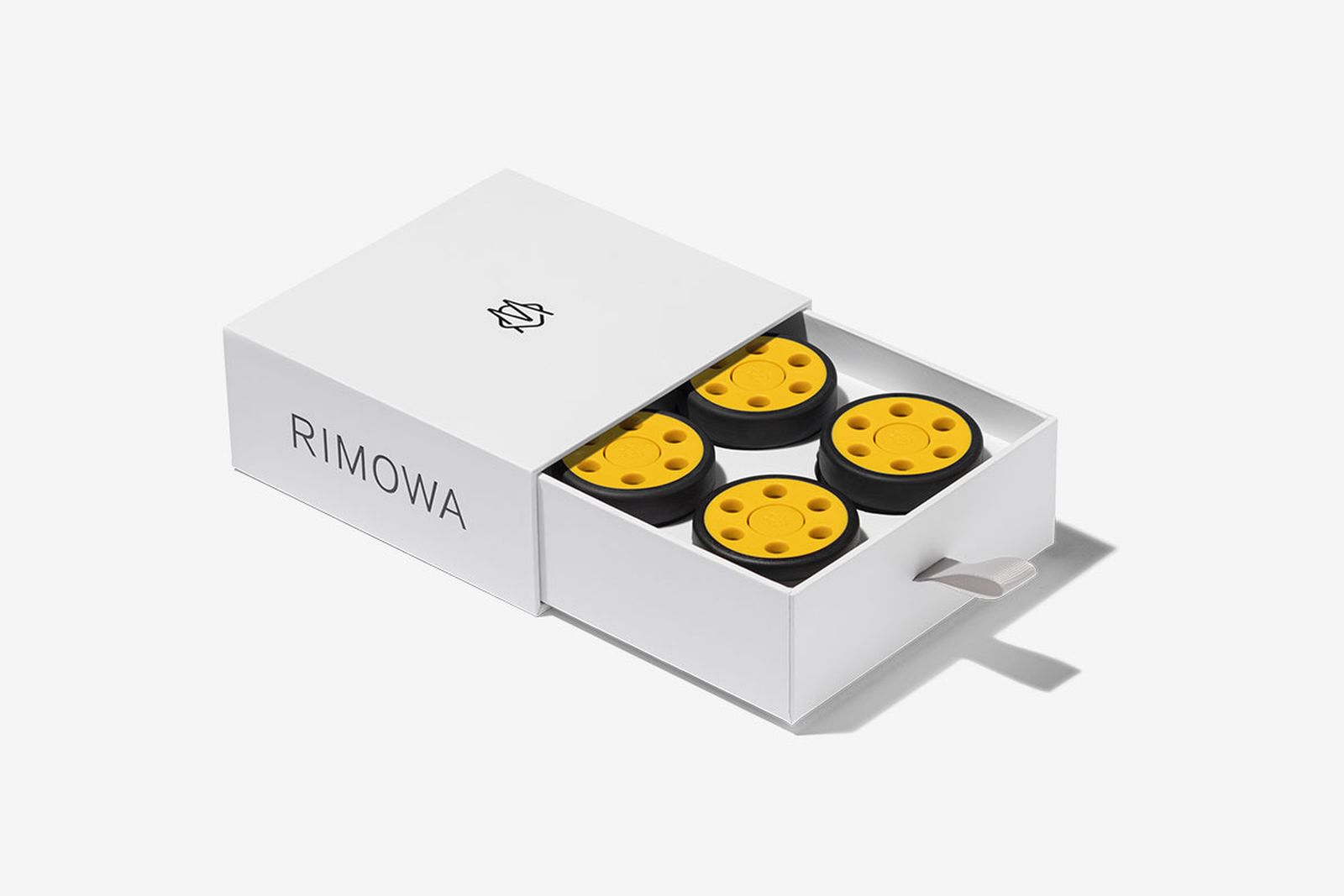 rimowa yellow wheels in a box