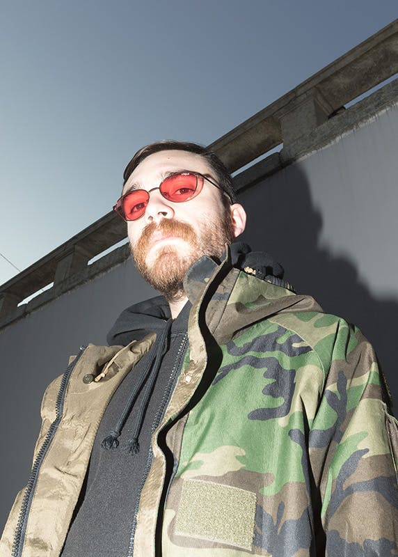 Alberto Panocchi wears Matteo Lamandini Studio pants, a Fuct sweatshirt and a vintage military parka.