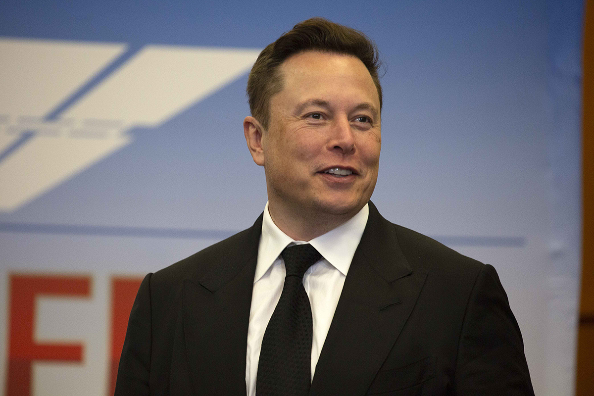 Elon Musk suit tie smiling