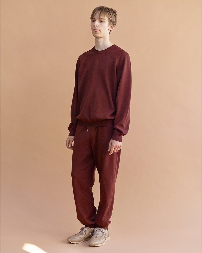 On model shot of a sweatshirt and sweatpants by Auralee
