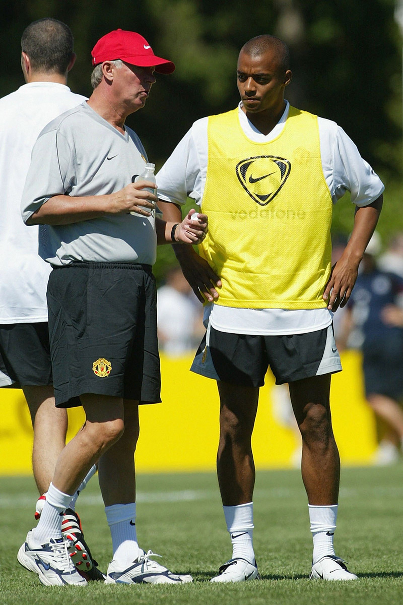 Sir Alex Ferguson of Manchester United talks with new signing David Bellion during their first training session of their American Tour on July 20, 2003.