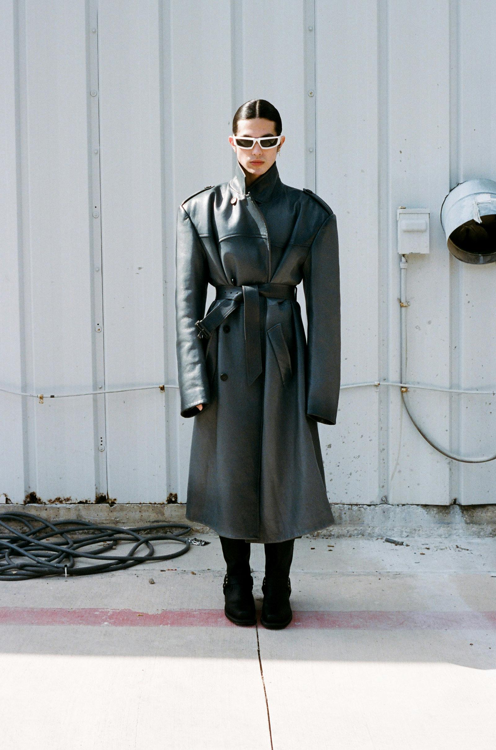 Top CALVIN KLEIN Pants, coat, and sunglasses PRADA Earring BRITT BOLTON JEWELRY Top necklace, bottom necklace pendant, and ring on right middle finger DAVID YURMAN Bottom necklace and ring on left index finger TITLE OF WORK Rings on right index finger PANDORA Boots FRYE