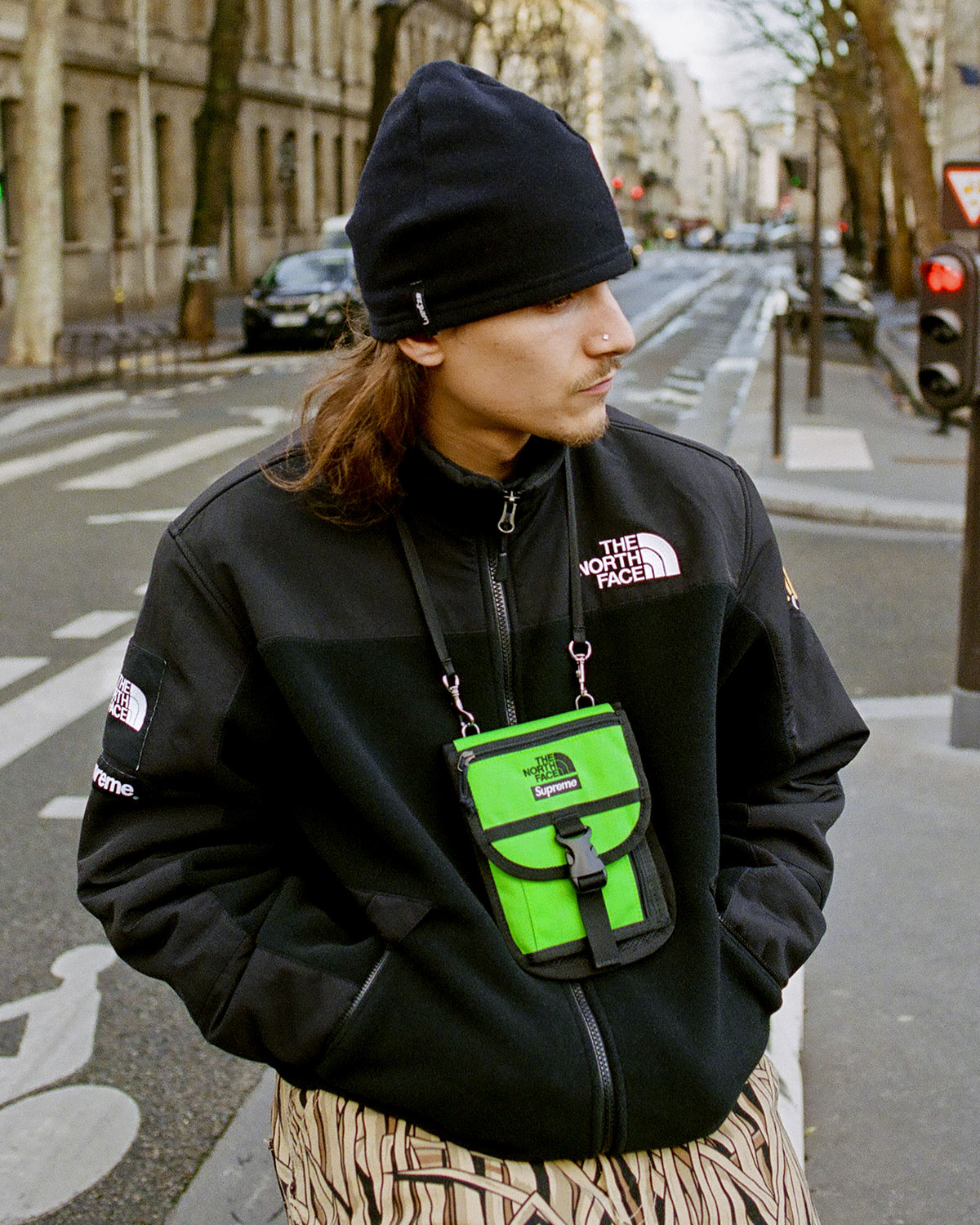 Man Wearing Supreme x The North Face RTG Fleece Jacket in Black With Lime Green Bag
