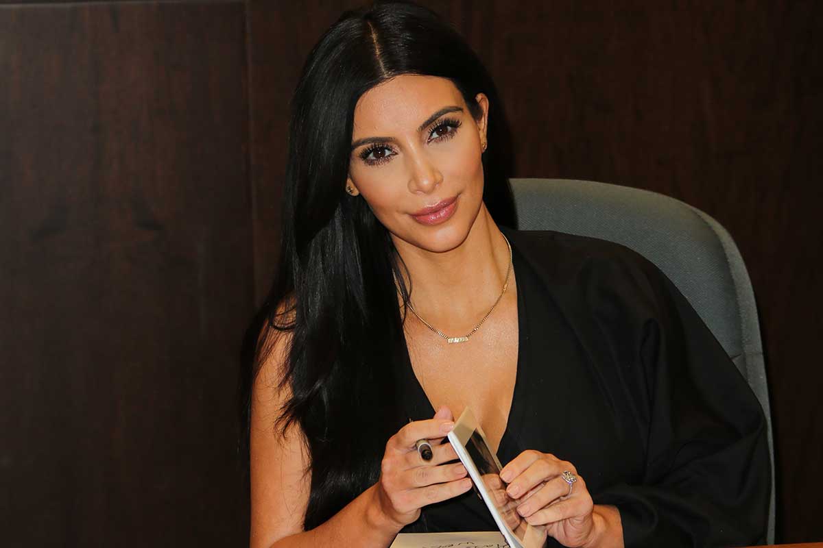 Kim Kardashian signing her selfie book