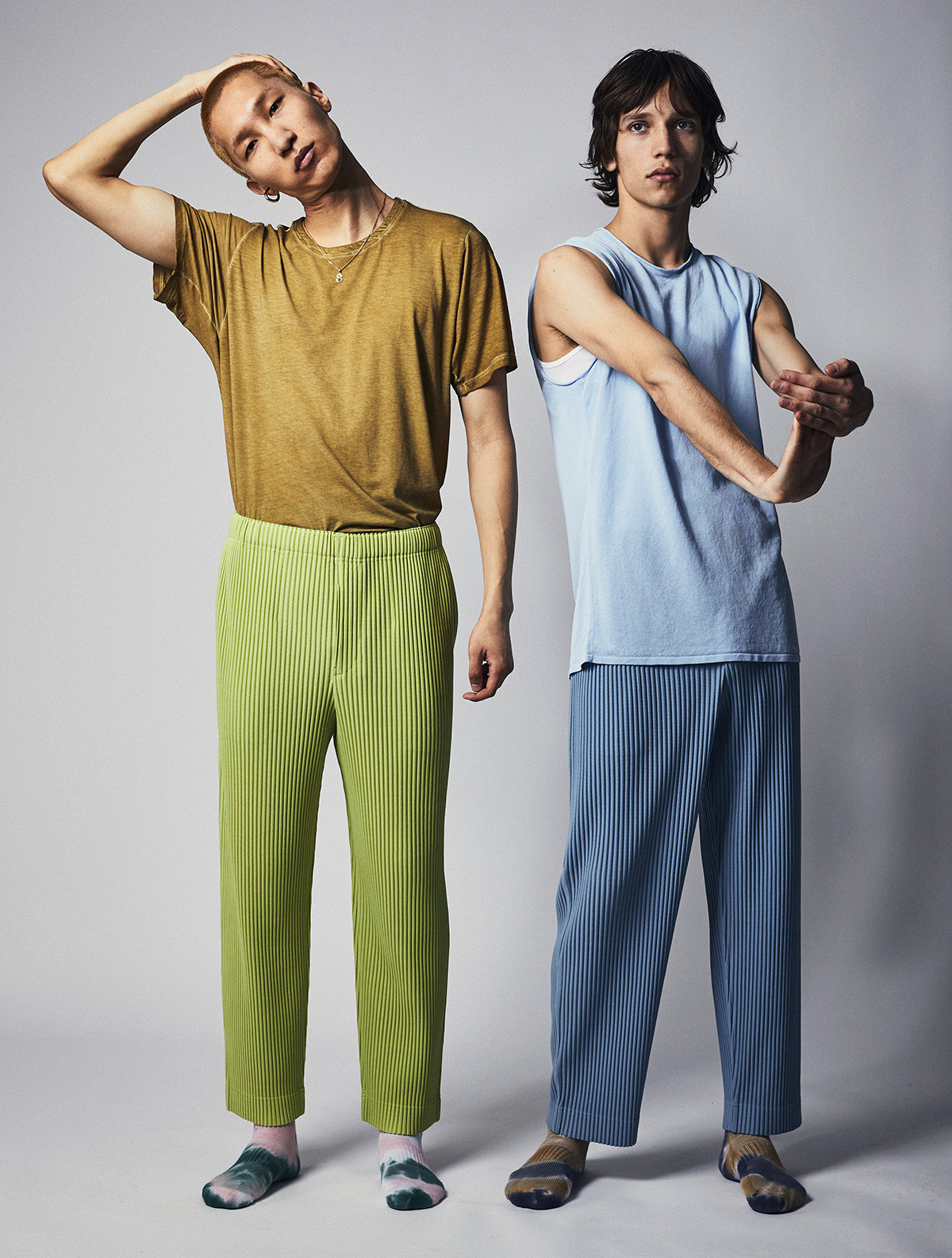 On Wooseok (left) T-shirt LULULEMON x ROBERT GELLER / Trousers by HOMME PLISSE ISSEY MIYAKE / Necklace Models own / Socks N/A / On Eliseu (right) Tank COS / Tank (worn underneath) Stylists own / Trousers HOMME PLISSE ISSEY MIYAKE / Socks N/A