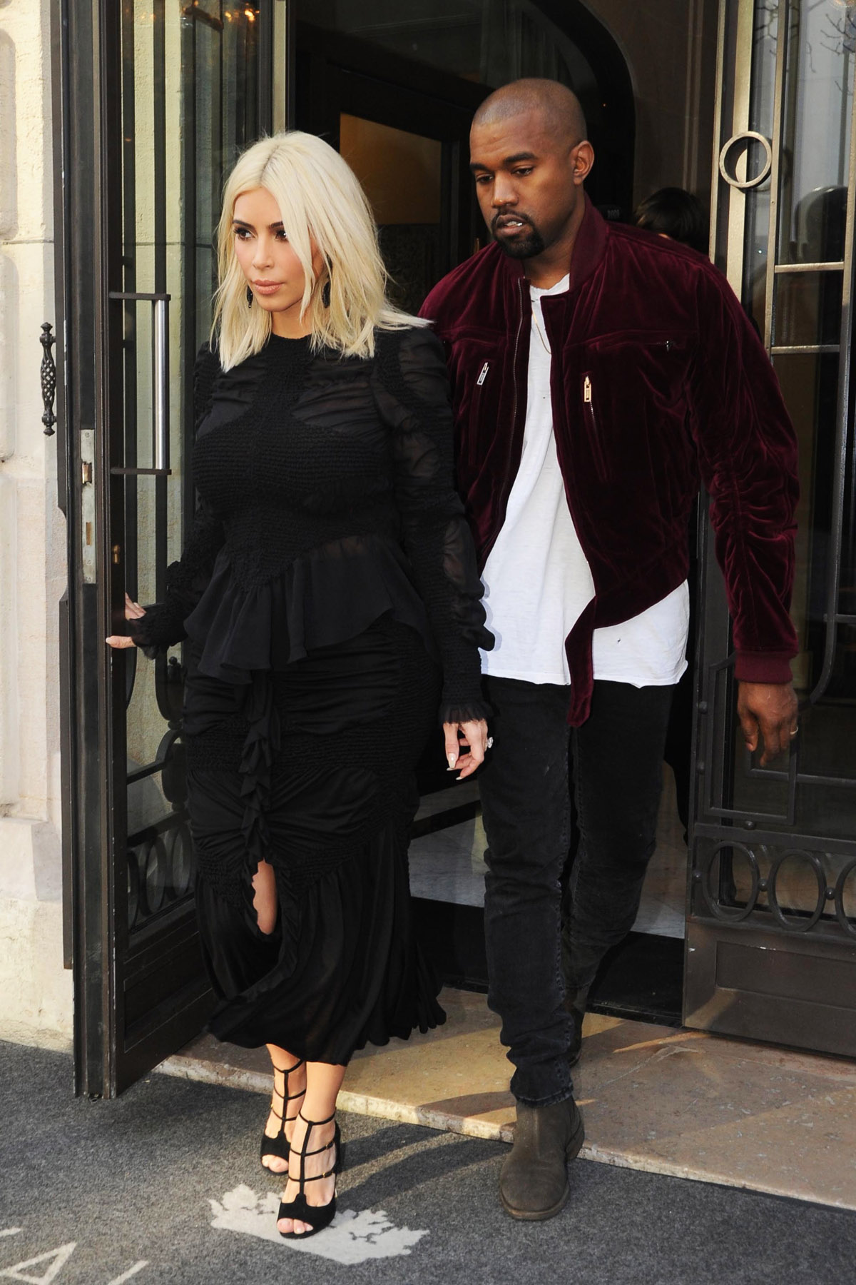 Kim Kardashian and Kanye West in and out of their hotel