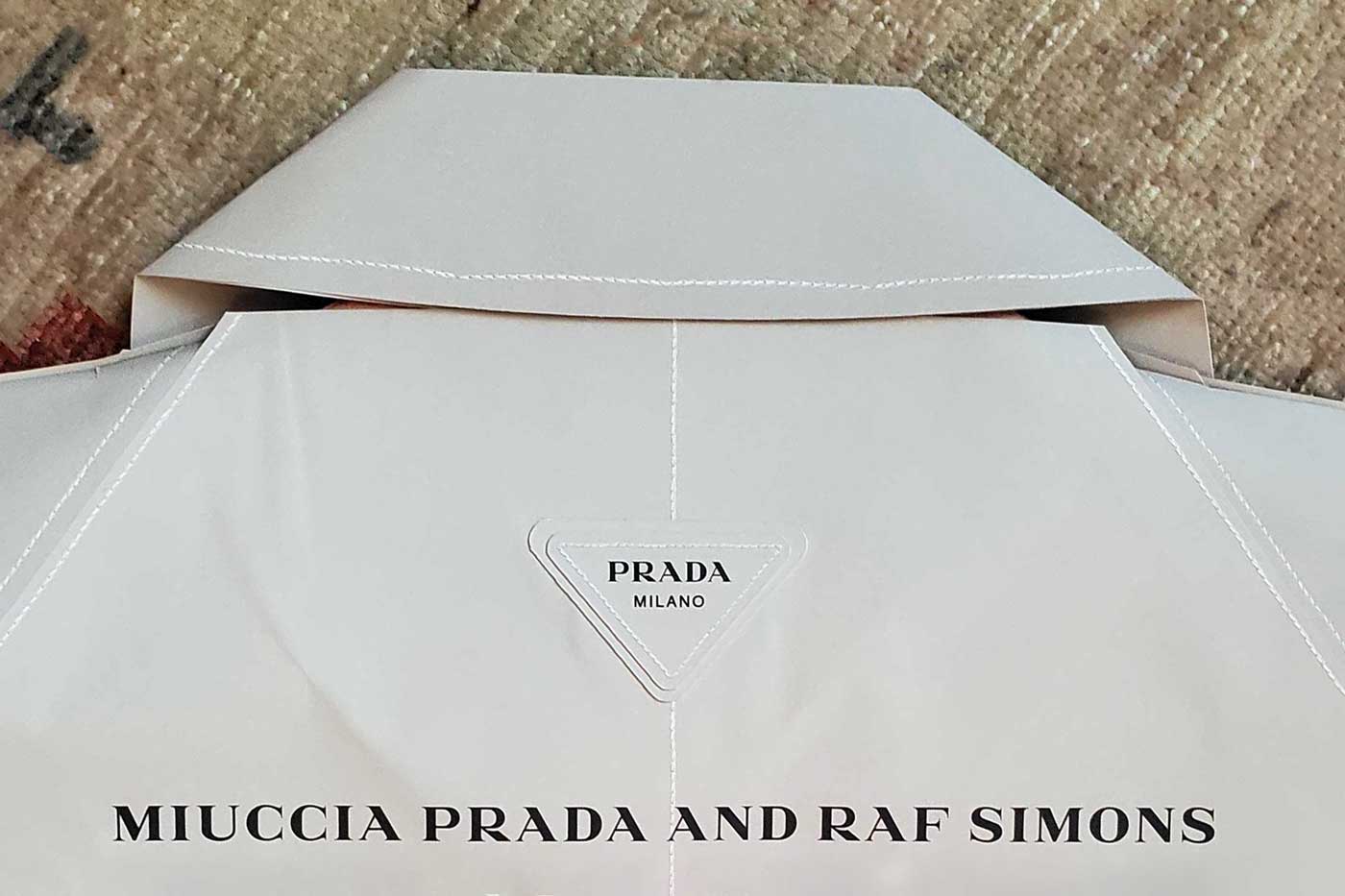 Prada's SS23 Show Invite Is a Paper Coat by Miuccia & Raf Simons