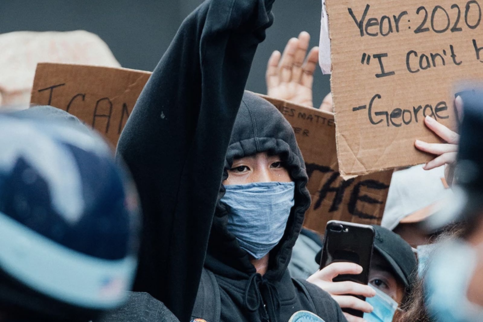 protester at George Floyd Protest in NY raised arm face mask