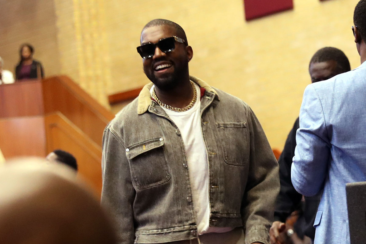 Kanye West smiling wearing shades