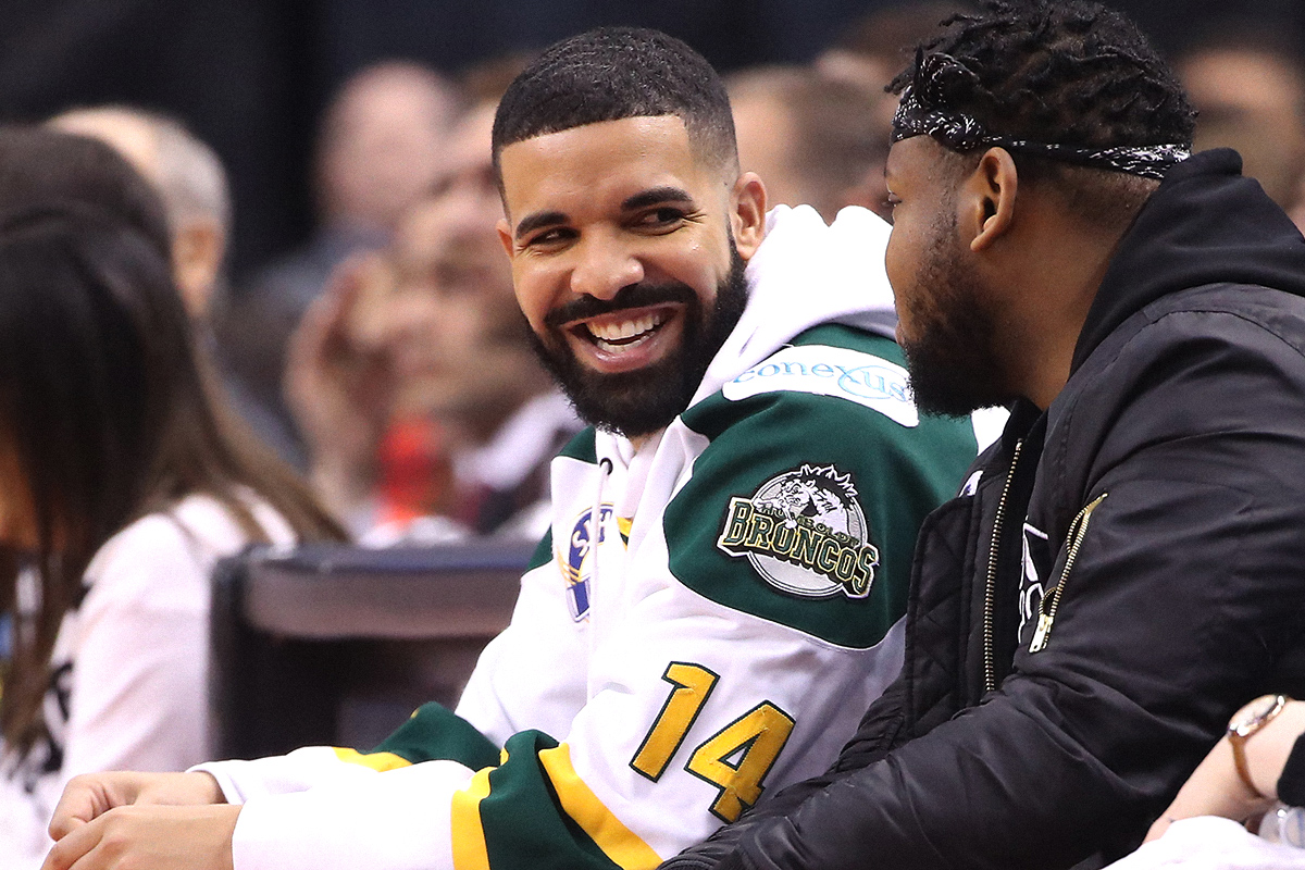 Rap artist Drake smiles as he wears a Humboldt Broncos jersey during the Toronto Raptors game against the Washington Wizards during Game One of the first round of the 2018 NBA Playoffs at Air Canada Centre on April 14, 2018 in Toronto, Canada.