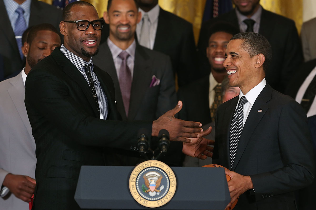 LeBron James (L) speaks to U.S. President Barack Obama (R) during an event to honor the NBA champion Miami Heat