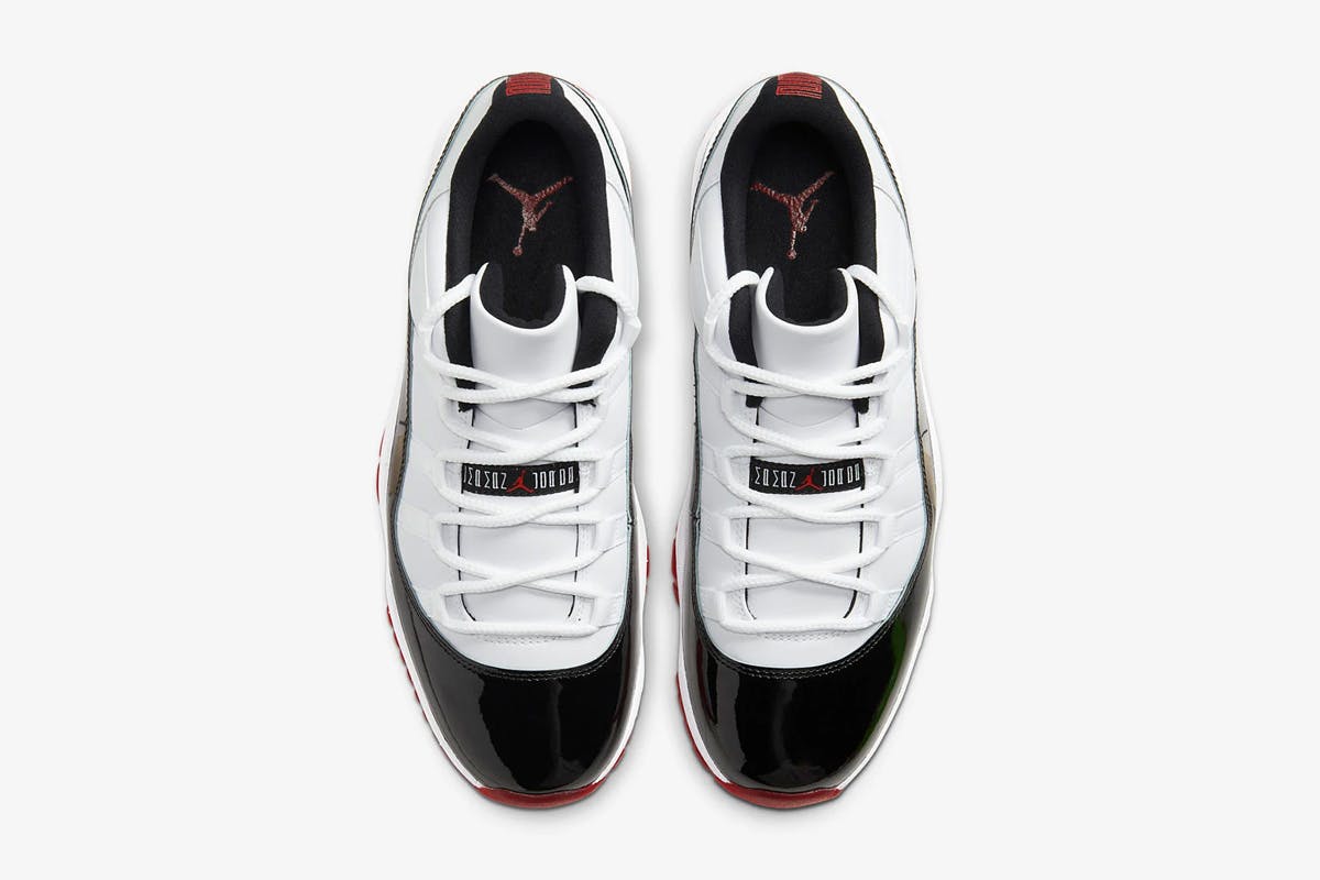 Product image of Nike Air Jordan 11 low in a black, white, and red colorway