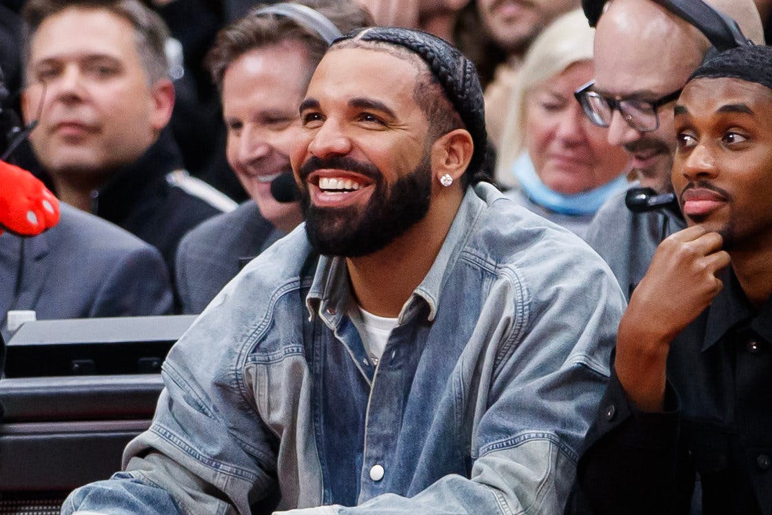 TORONTO, ON - NOVEMBER 23: Rapper Drake smiles as he sits courtside with Future The Prince during the second half of the NBA game between the Toronto Raptors and the Brooklyn Nets at Scotiabank Arena on November 23, 2022 in Toronto, Canada. NOTE TO USER: User expressly acknowledges and agrees that, by downloading and or using this photograph, User is consenting to the terms and conditions of the Getty Images License Agreement. (Photo by Cole Burston/Getty Images)